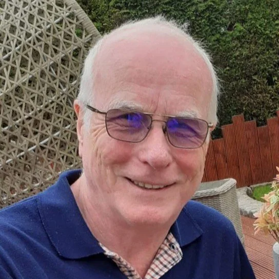 Board of Trustees member John posing for a photographing for a