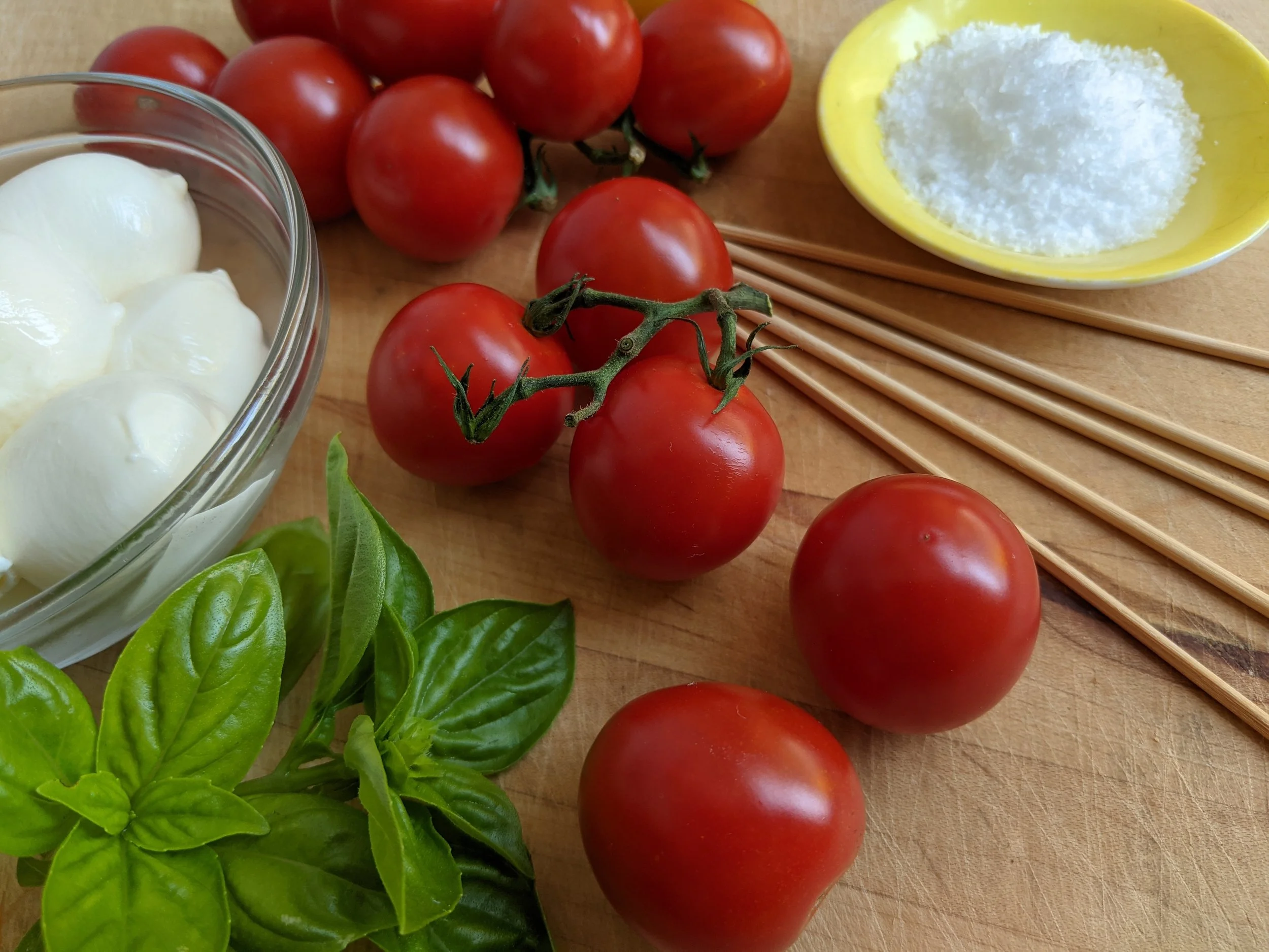 Tomato Tonatico_cutting board with basil, salt, ciliegine (mozzarella pearls) & skewers.jpg