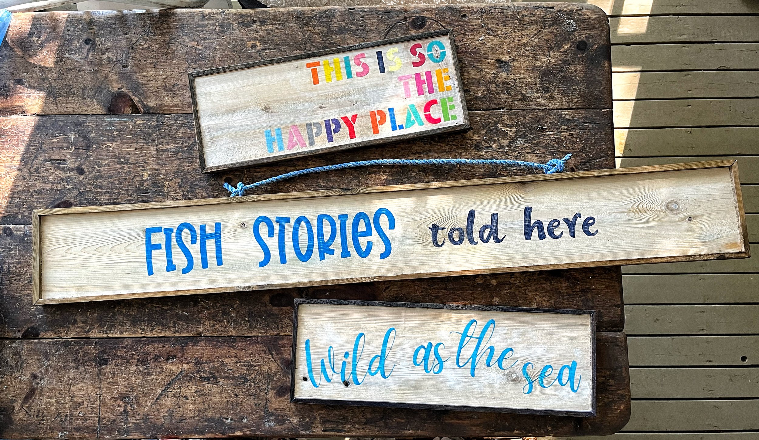 Repurposed cedar cut offs, hand painted and framed as wall art.