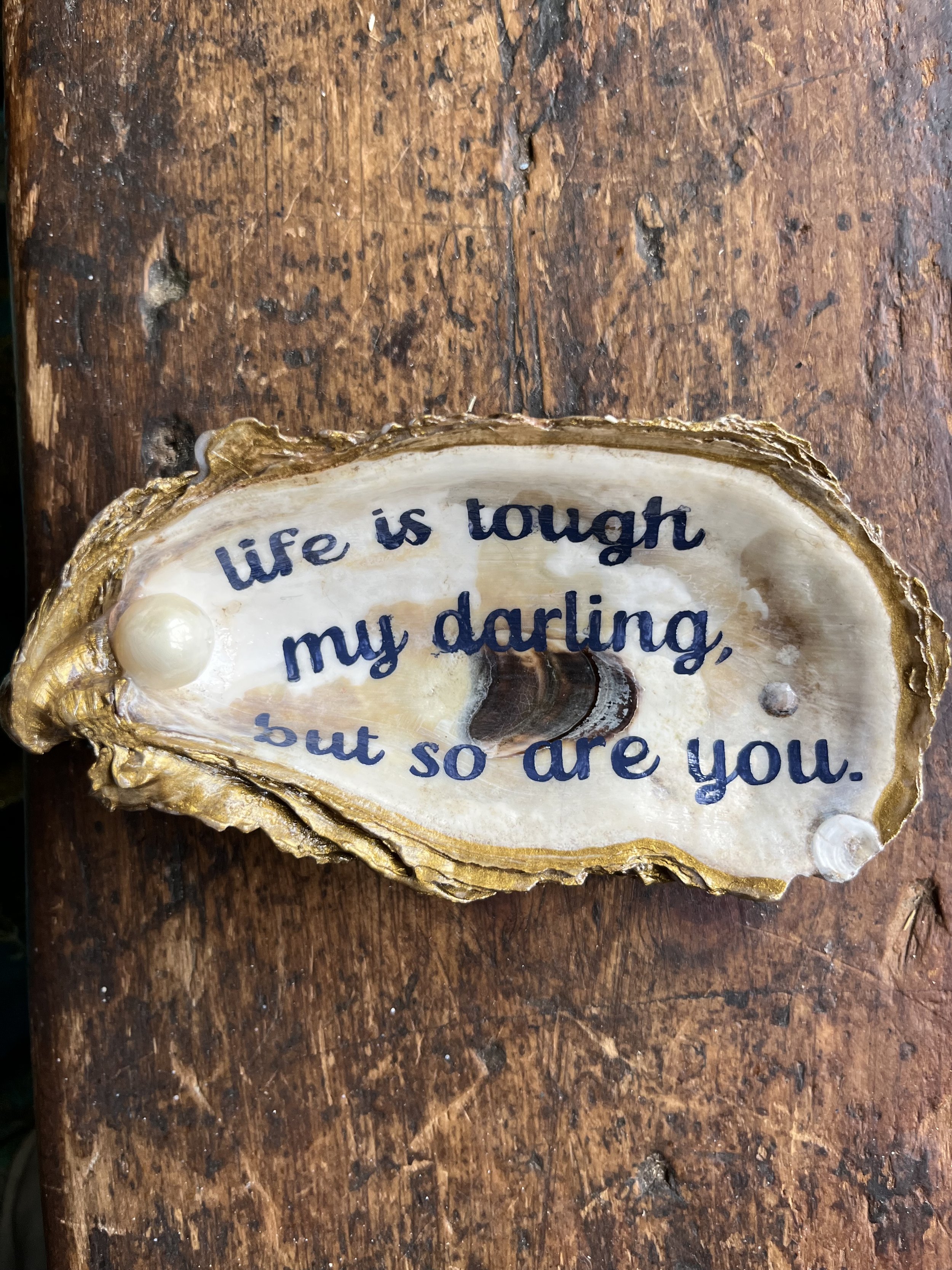 Washed up oyster shells that washed up so they could be gold dipped and hand painted. Ring, salt, spoon and anything holders make any table a little more interesting.