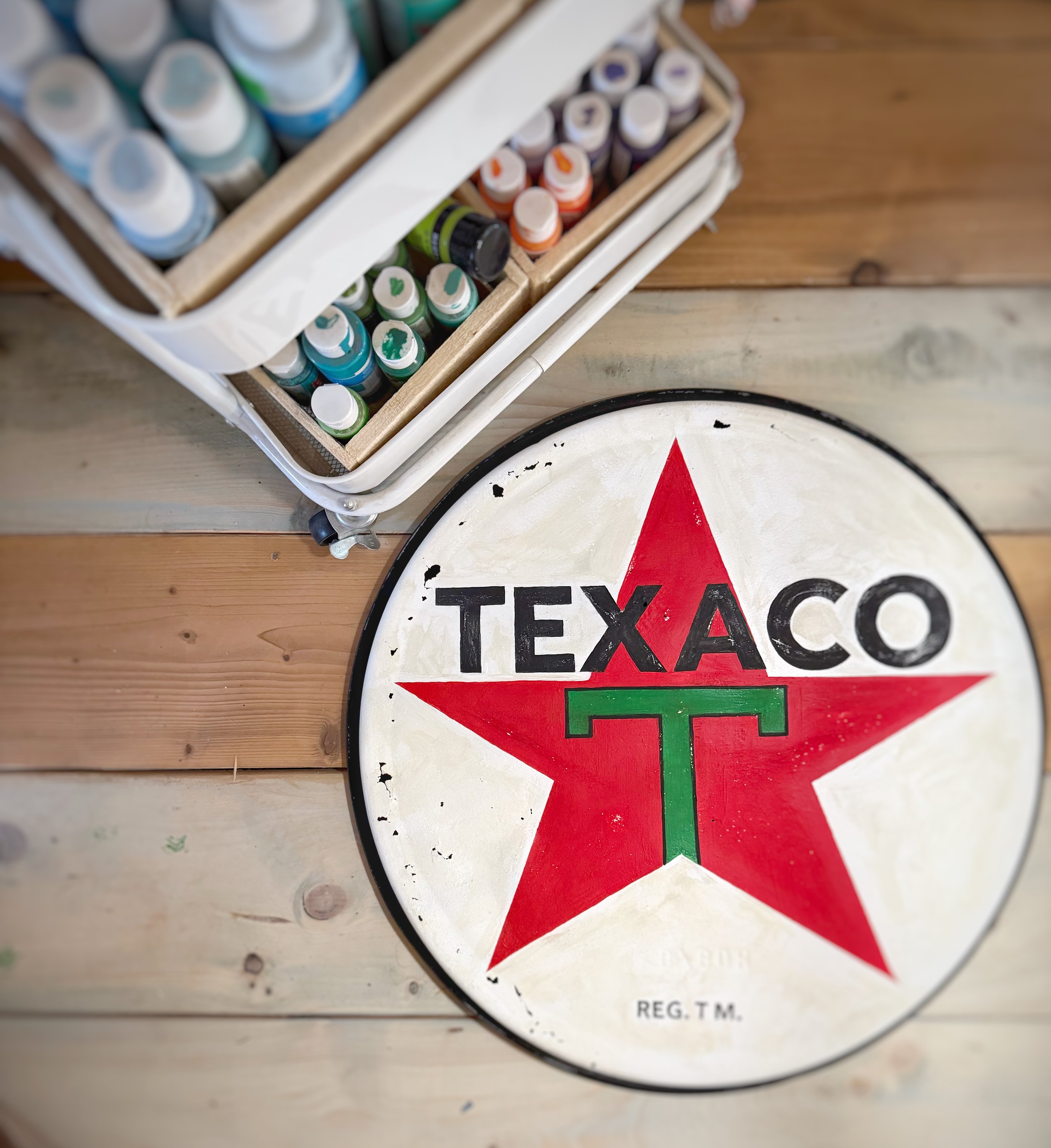 Old oil drum lid painted into old gas station sign.