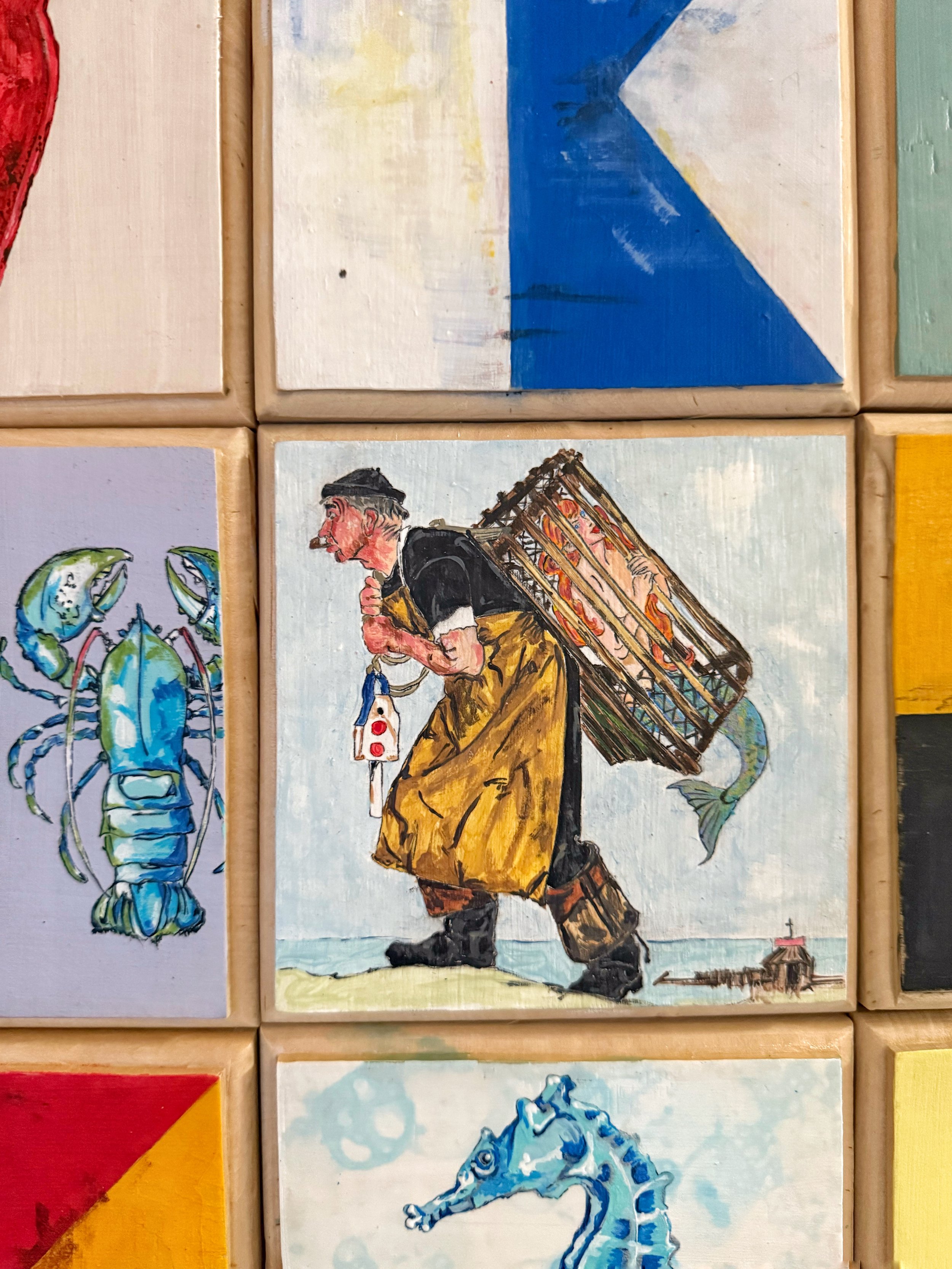 Salvaged cedar tiles, hand painted and turned into wooden wall quilts.