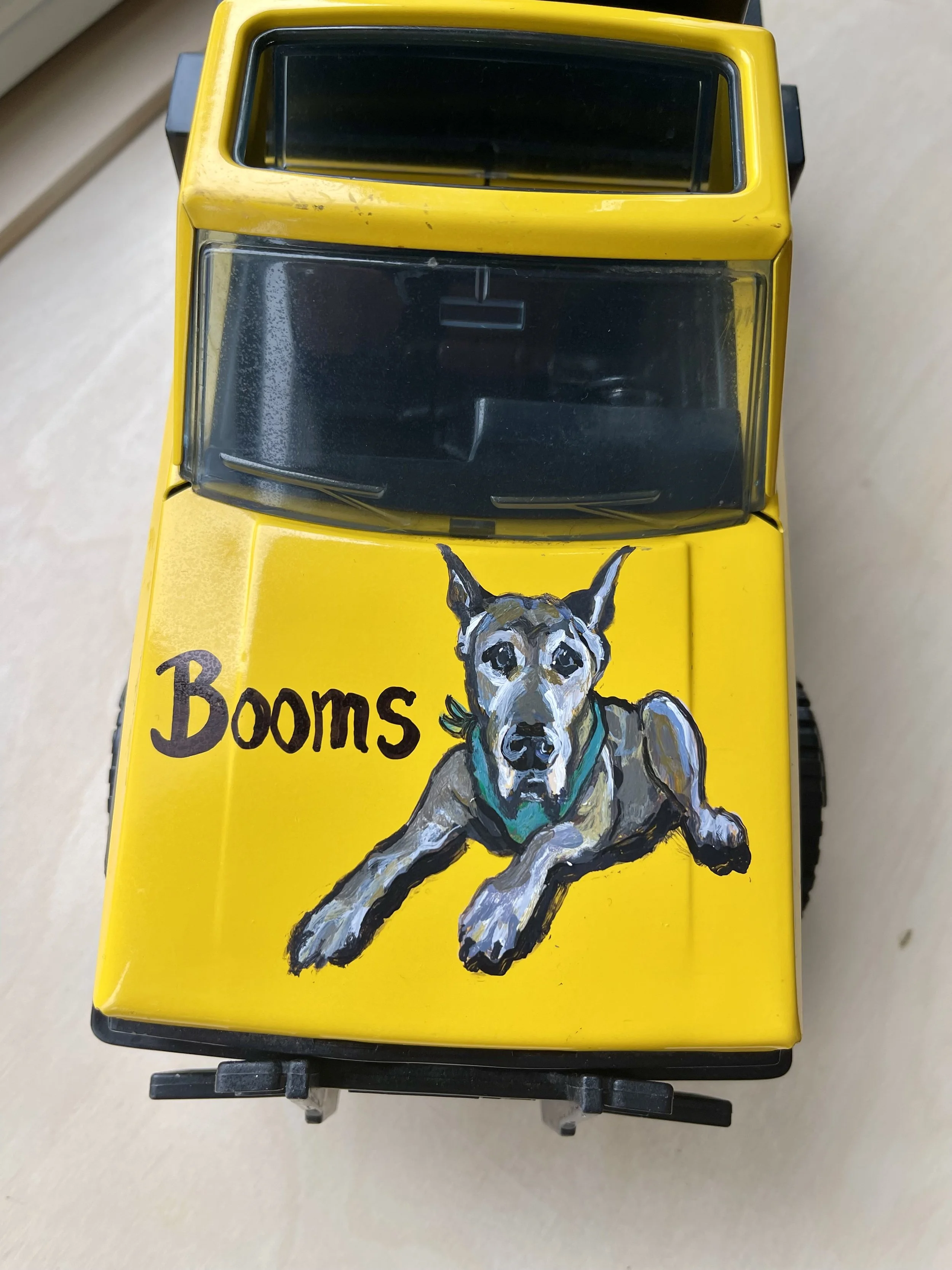 Custom memorial creation of a beloved dog , (Boomer) on a tow truck (the father works with tow trucks).  
