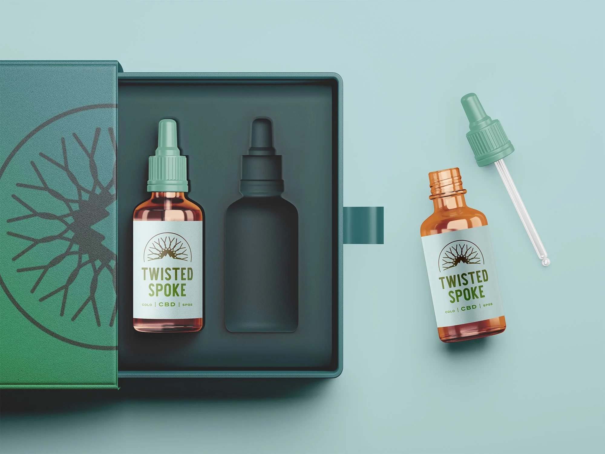 Two bottles of Twisted Spoke CBD oil, one inside a box and one outside, with droppers beside them on a light blue background.