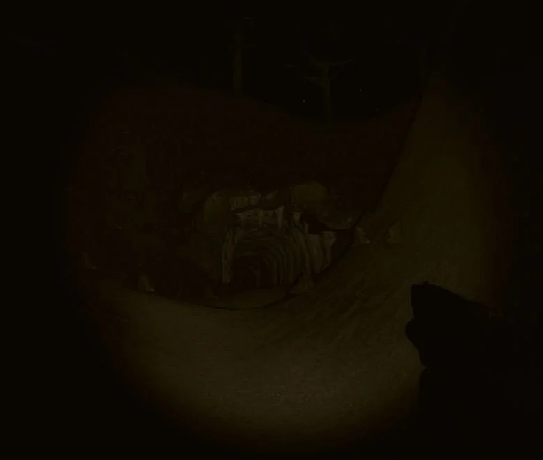 A dark and dimly lit scene, possibly an underground tunnel or mine with a person standing or crouching near a winding pipe or conduit.