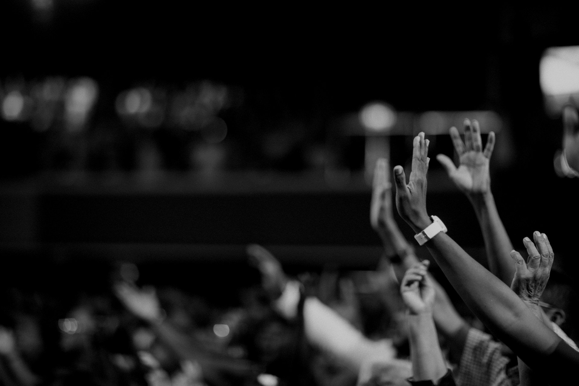 Hands raised in a worship service.