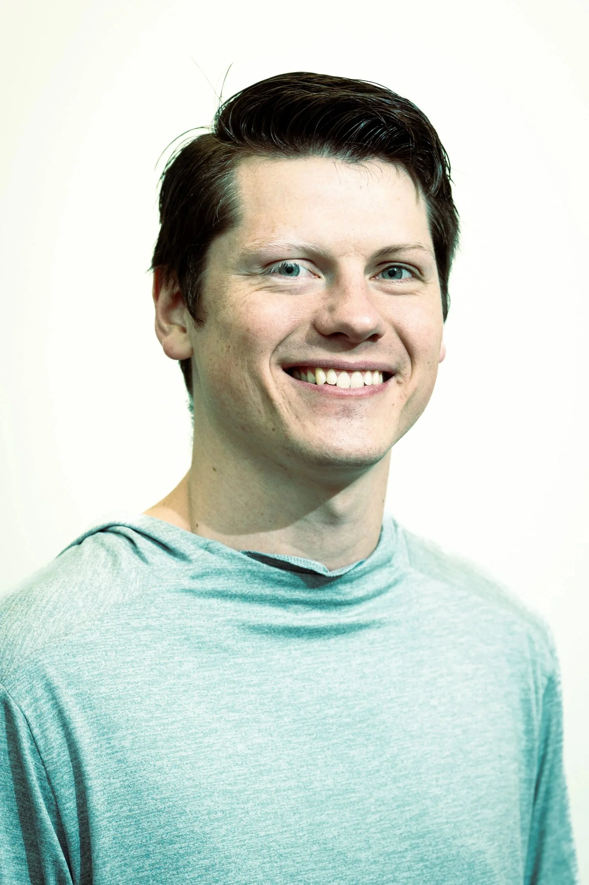 Man with blue eyes and brown hair, smiling.