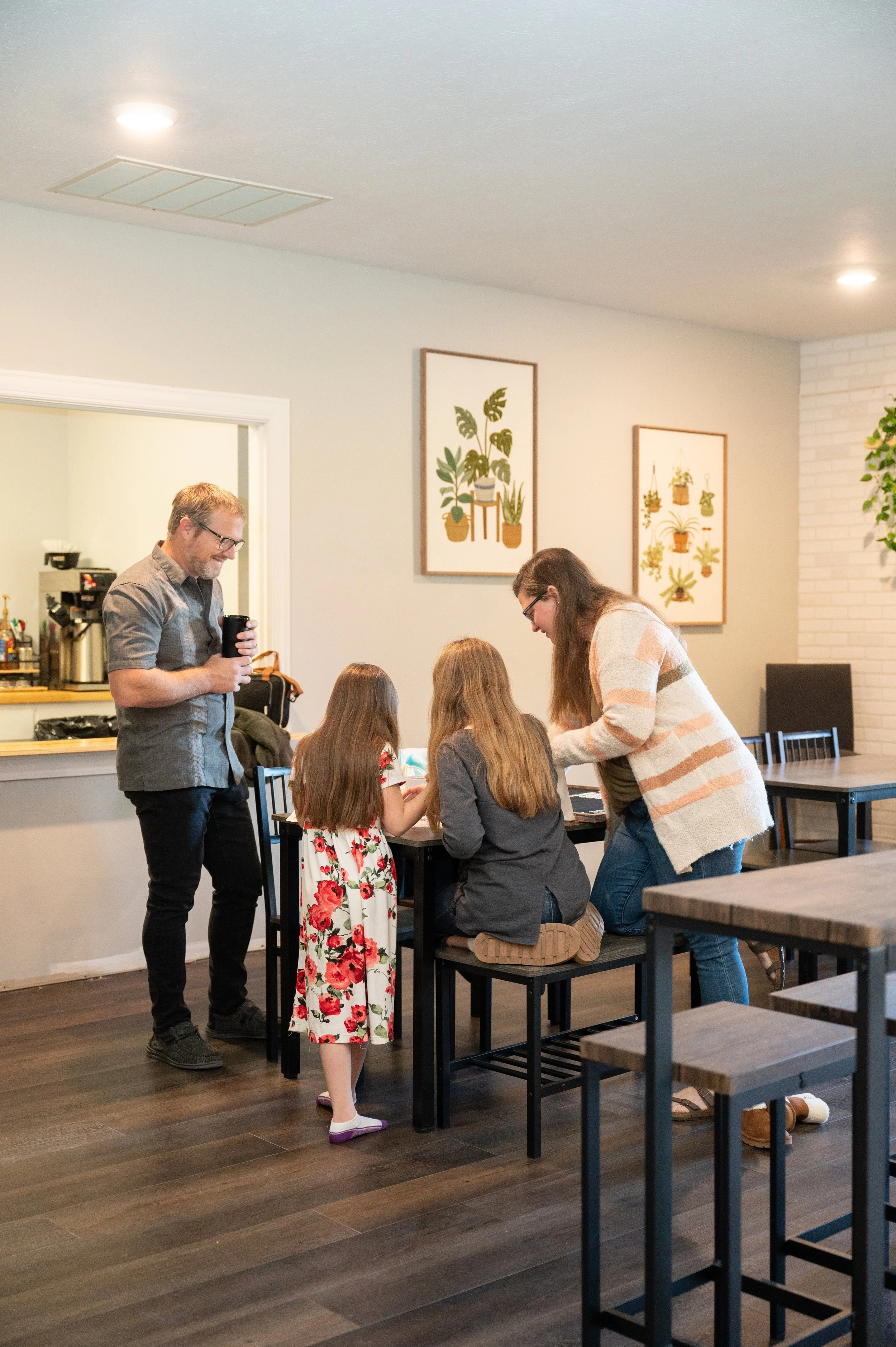 Parents and two children gathered around a table.