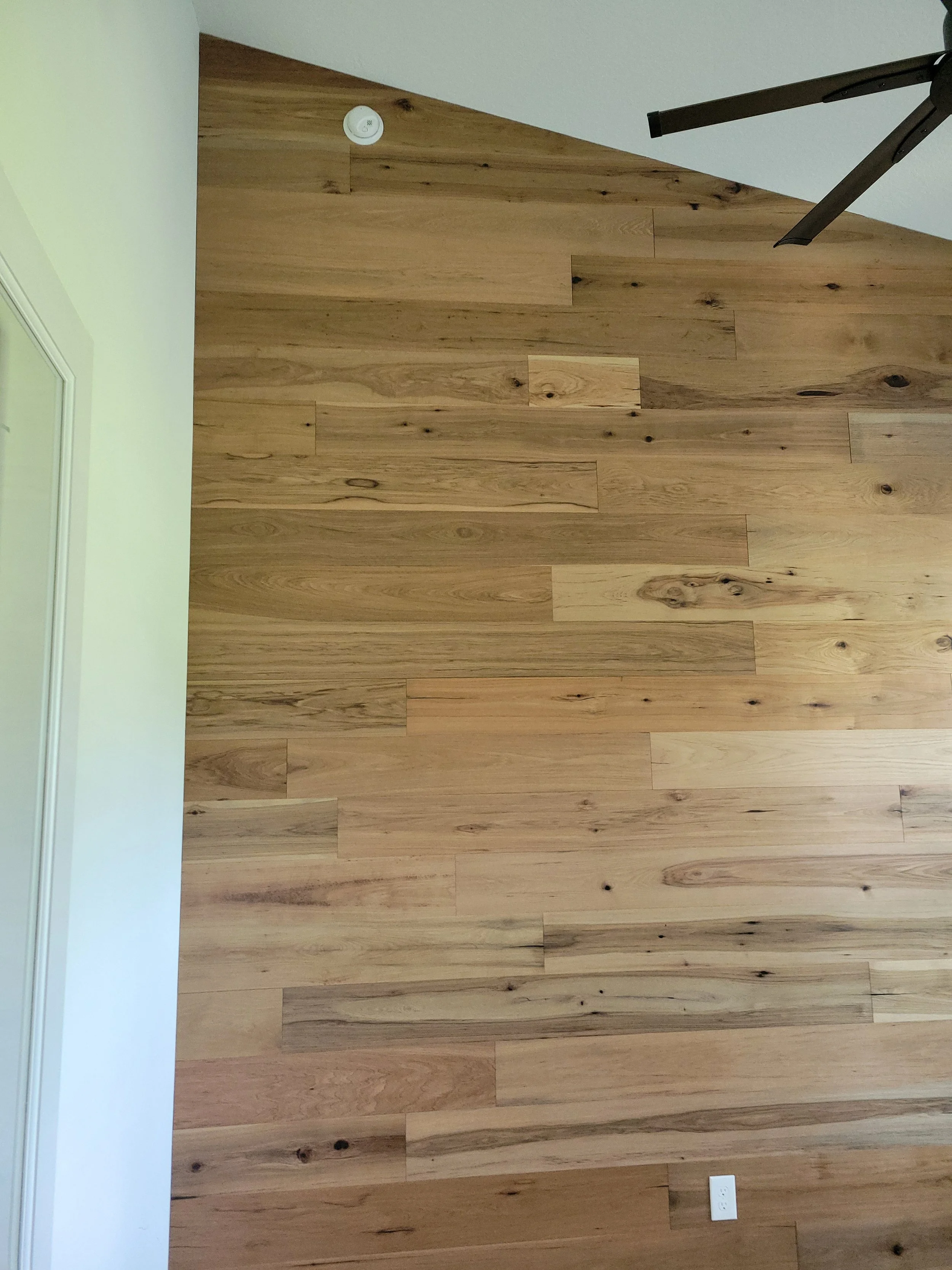 A wooden accent wall with natural wood planks.