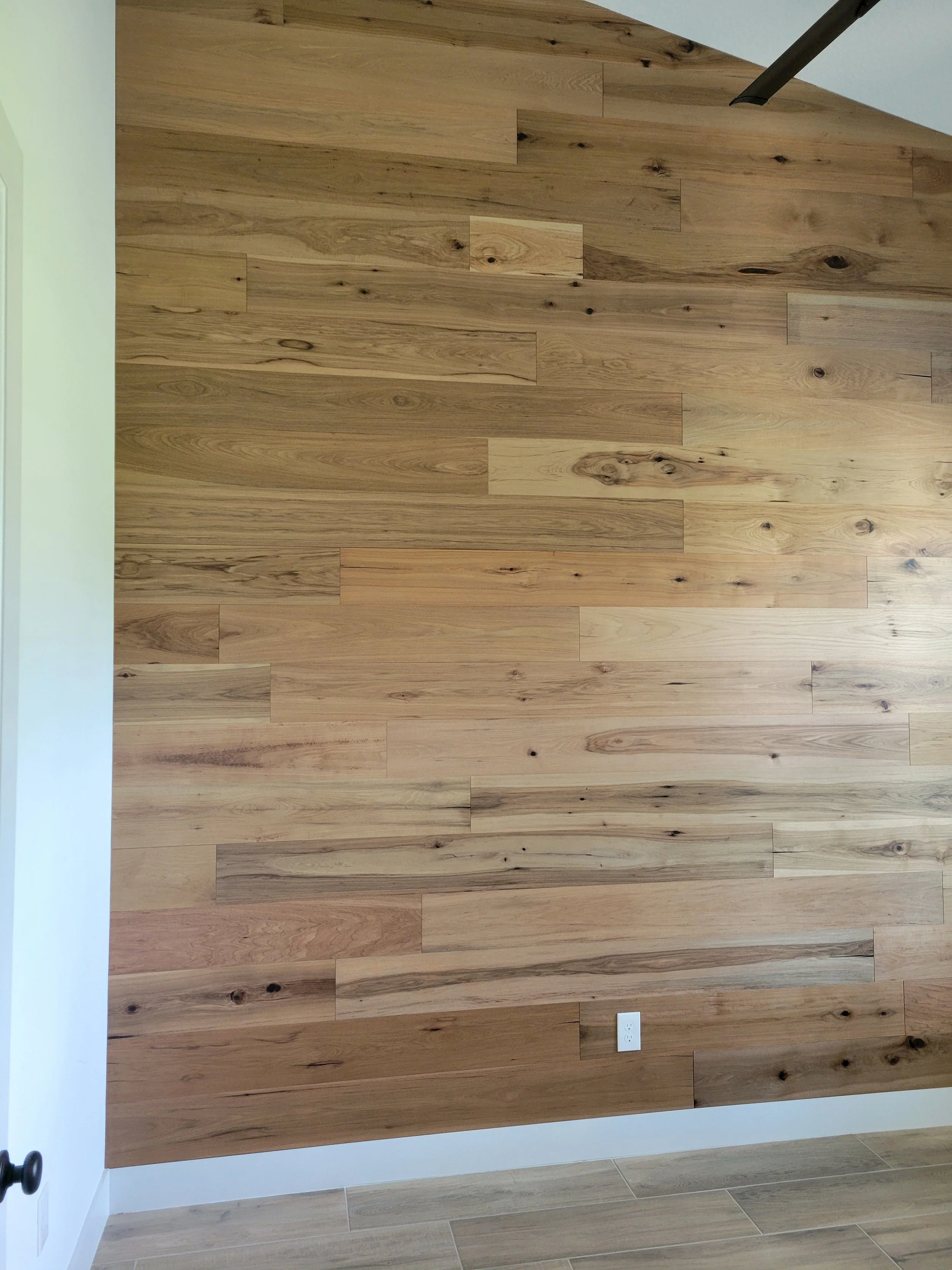 Interior room featuring a wooden accent wall with horizontal planks.