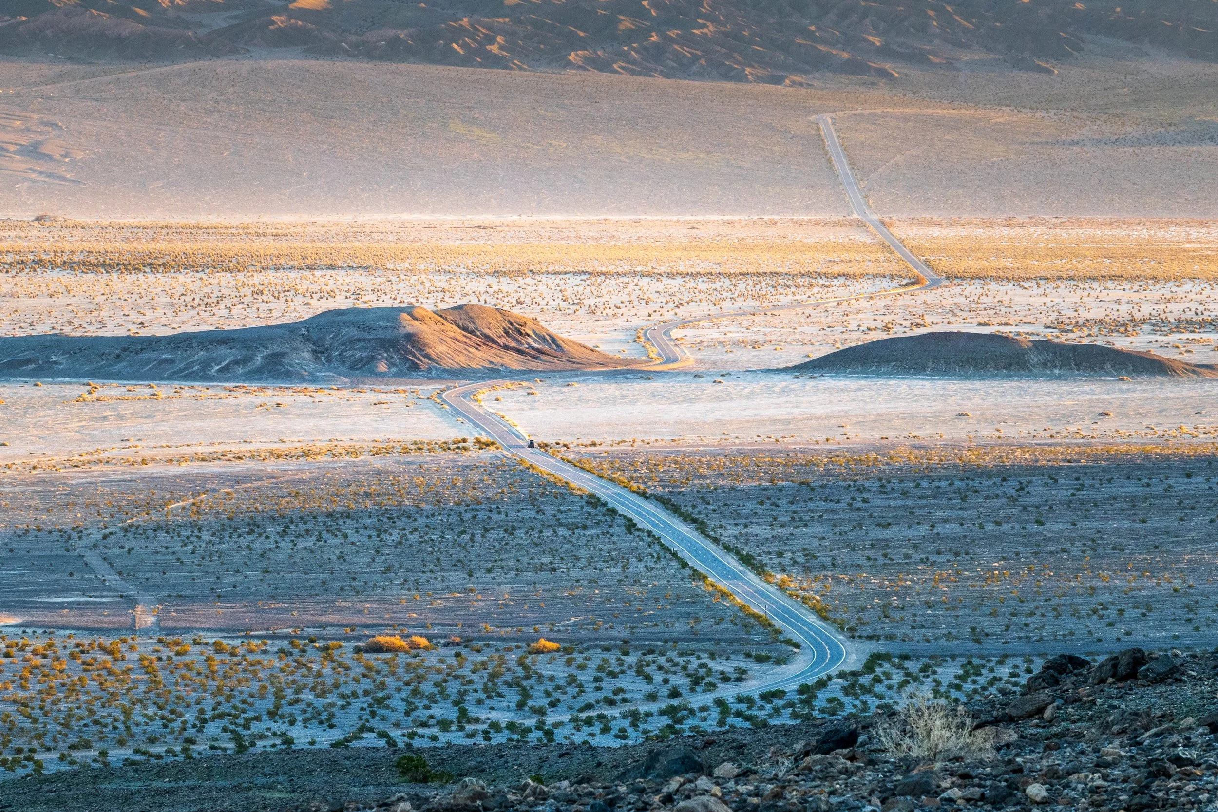 The road to Furnace Creek - as the sun rose over Stovepipe Wells the road north stretched into the distance. Death Valley is one of the largest national parks, and the distances are vast.