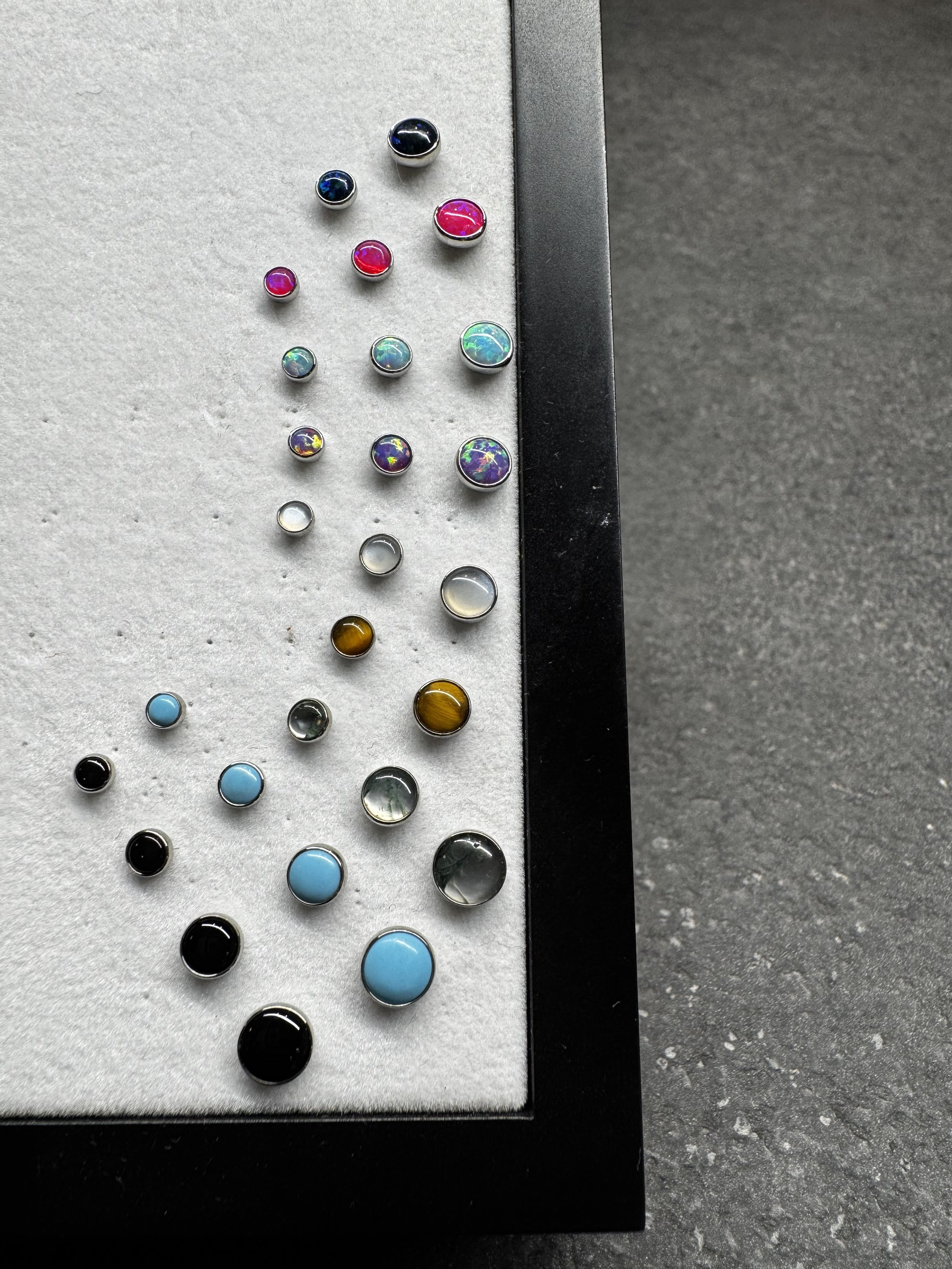 Bezel set cabochon opals and natural stones suitable for all piercings. Made from implant grade titanium