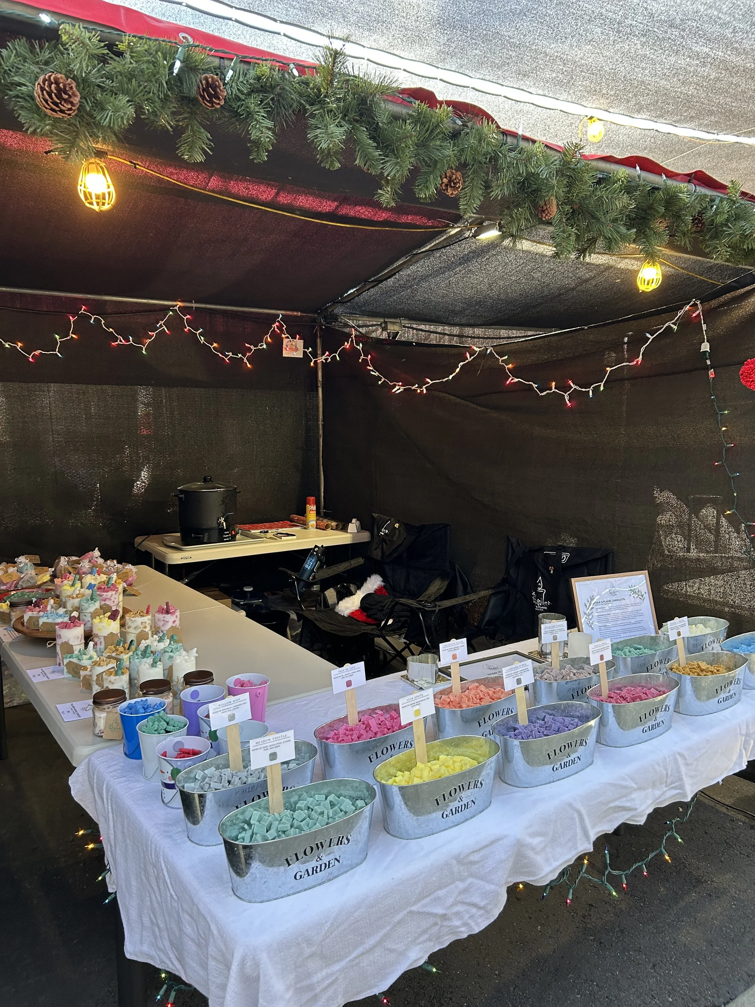 Our display at a local San Diego holiday market. The photo features our tubs of wax cubes where you can make your own candle. The table also have our pre-made candles, wax melts and floating candles.