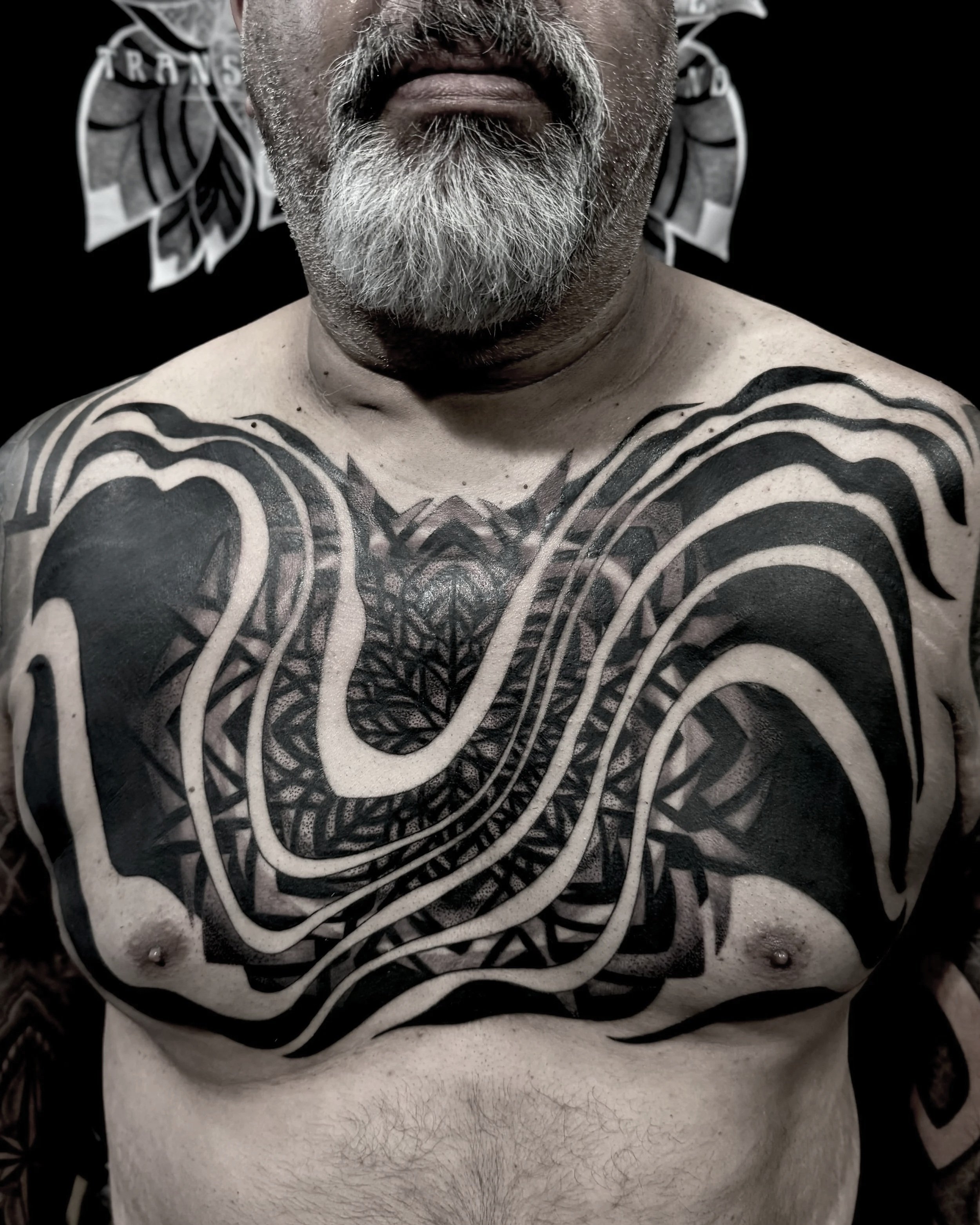 bold fluidic tribal mandala chest piece Hermosa beach tattoo shop