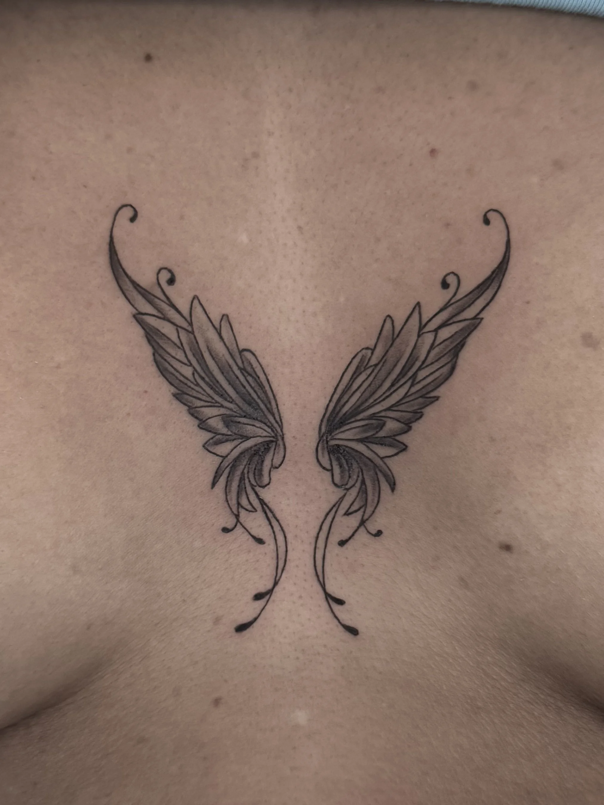 Angel wings woman chest ornamental tattoo Hermosa Beach