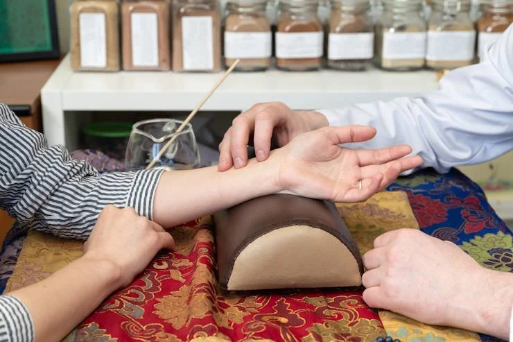 Traditional Chinese Medicine practitioner performing a pulse diagnosis during a health consultation in Taiwan.