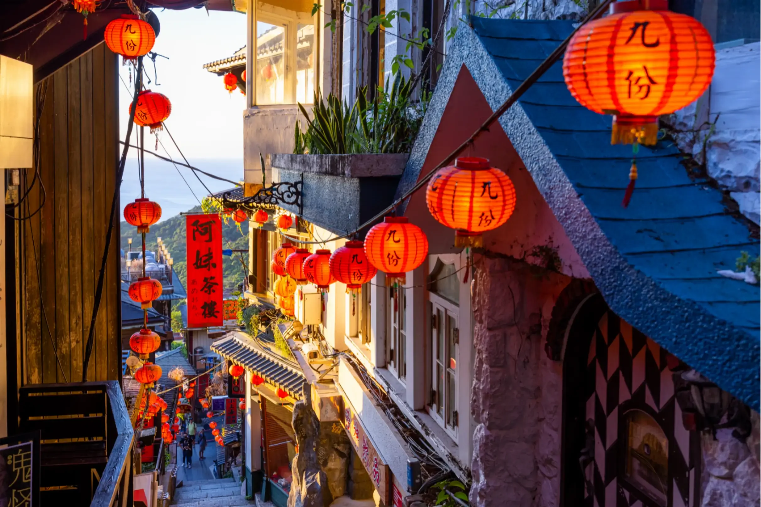 Traditional Taiwanese alleyway lined with glowing red lanterns.