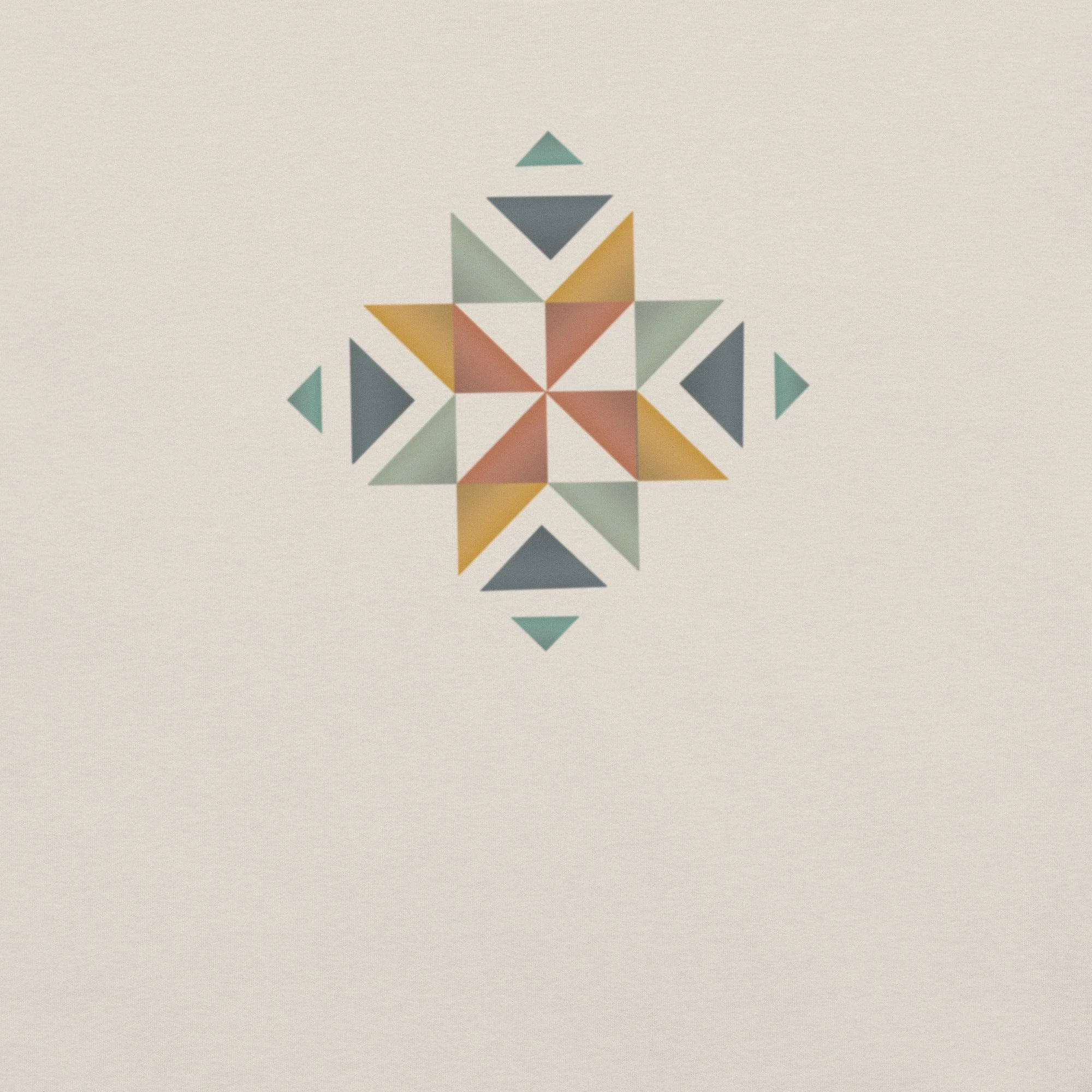 The front of a white shirt with a beautifully designed quilt block in multiple colors on the front.