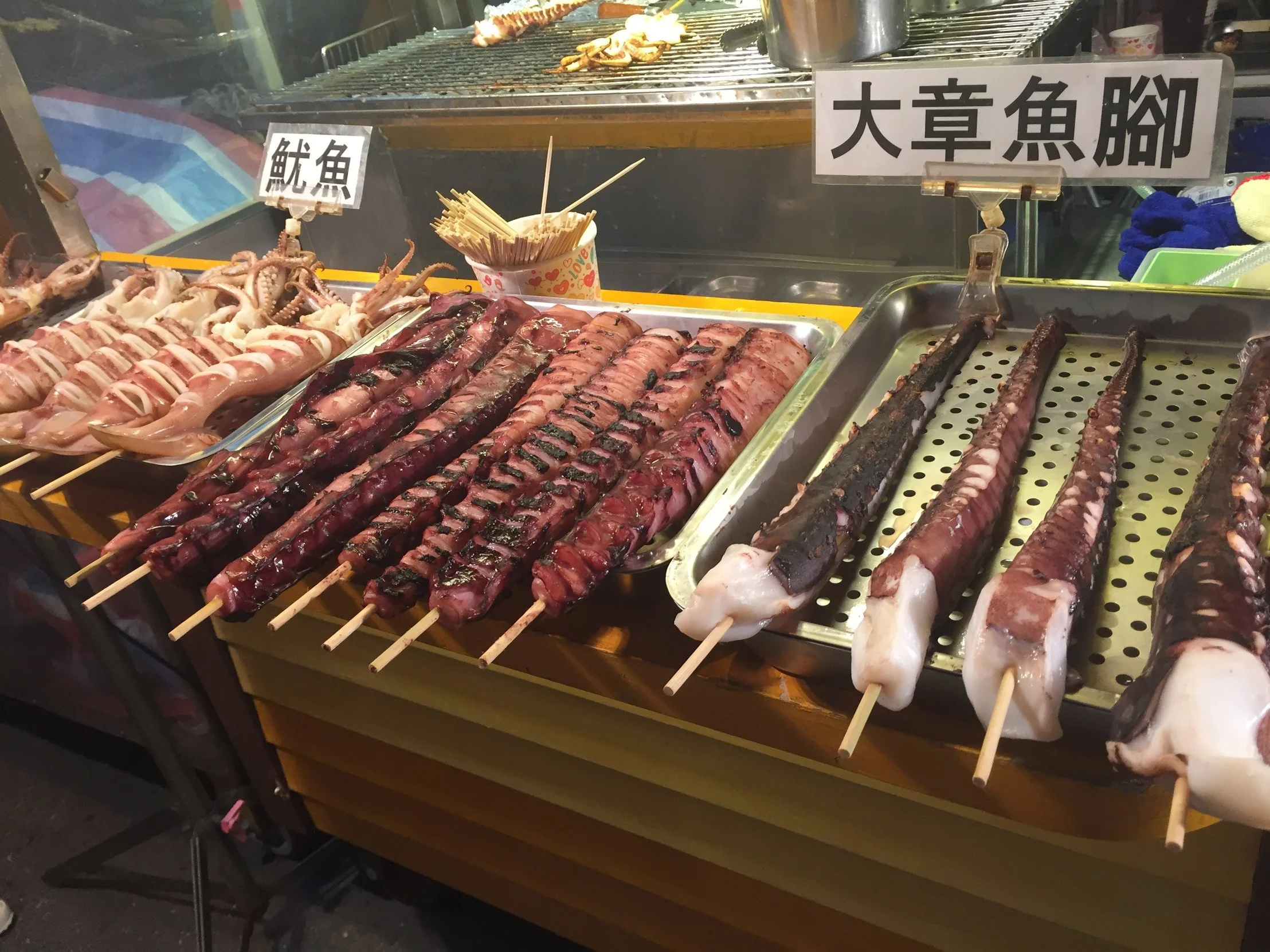 Various meats on sticks in an open air market in Taiwan during a Tricia Pomering Cultural Experience.