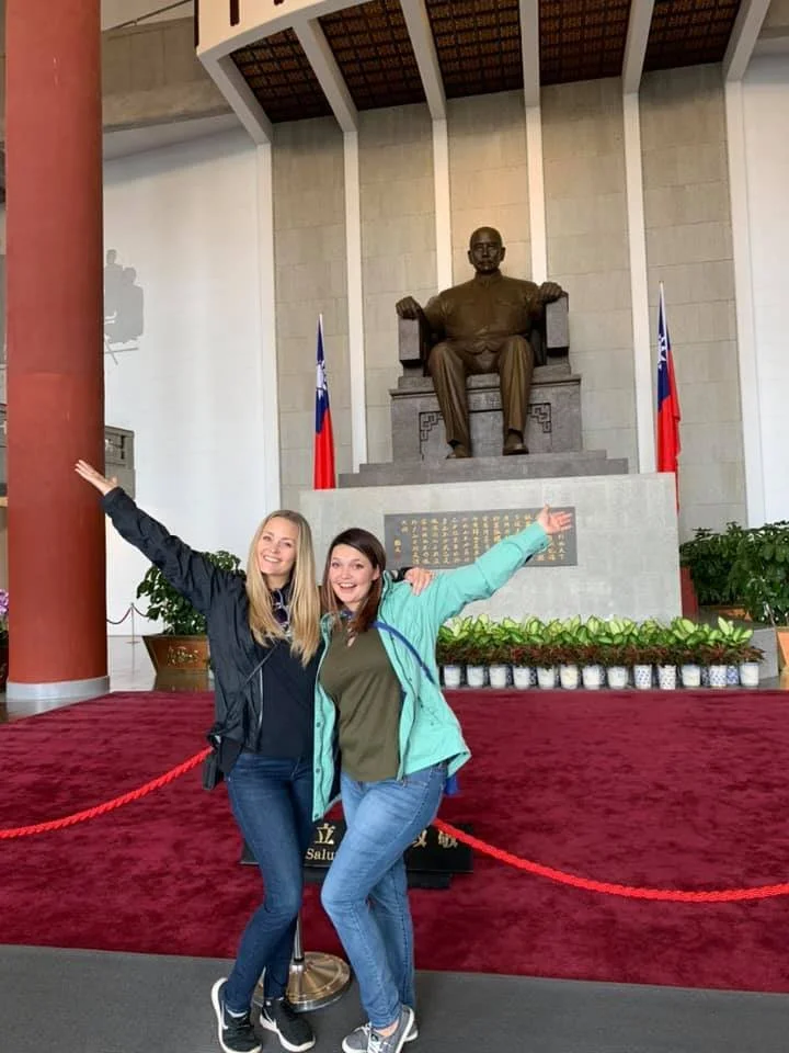 Tricia Pomering and guest pose in front of the Chiang Kai Shek Memorial Statue during a Tricia Pomering Cultural Experience in Taiwan.