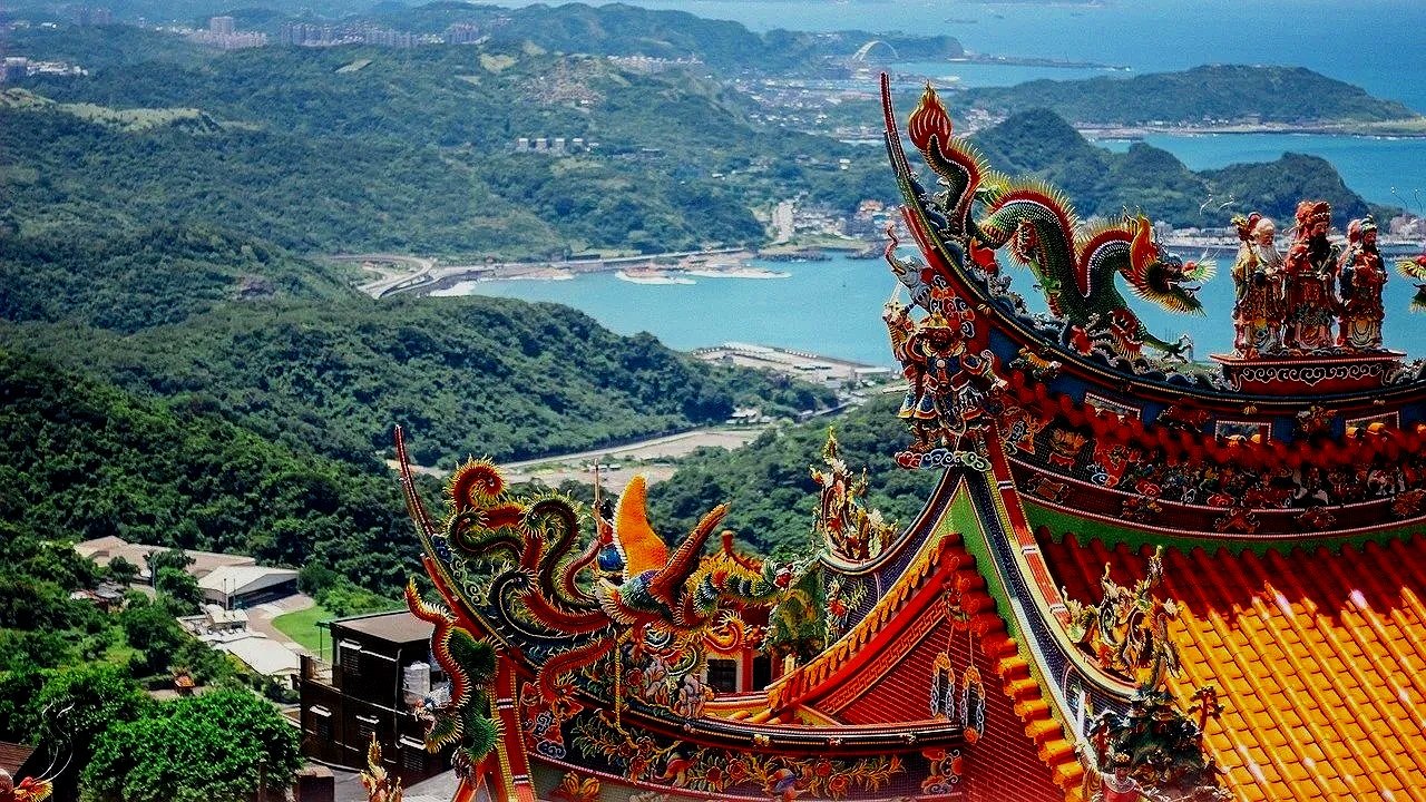View from a traditional Taiwanese temple with the ocean and coastline visible below.