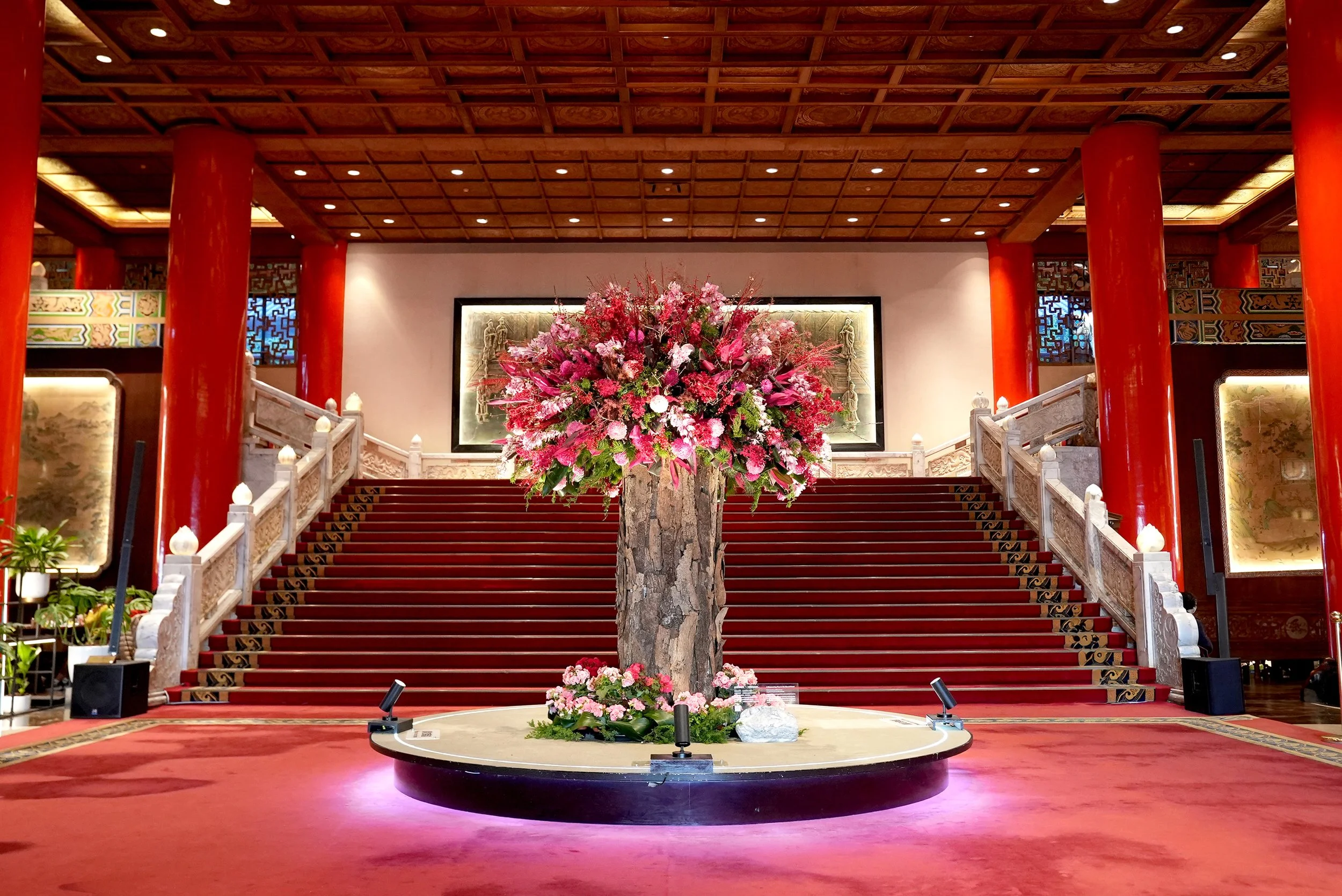 Large floral arrangement in a hotel lobby featuring traditional Taiwanese architecture.