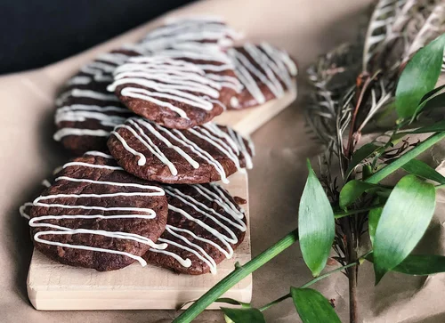 Decorated cookies on a wooden board for Cook Girls Bakery