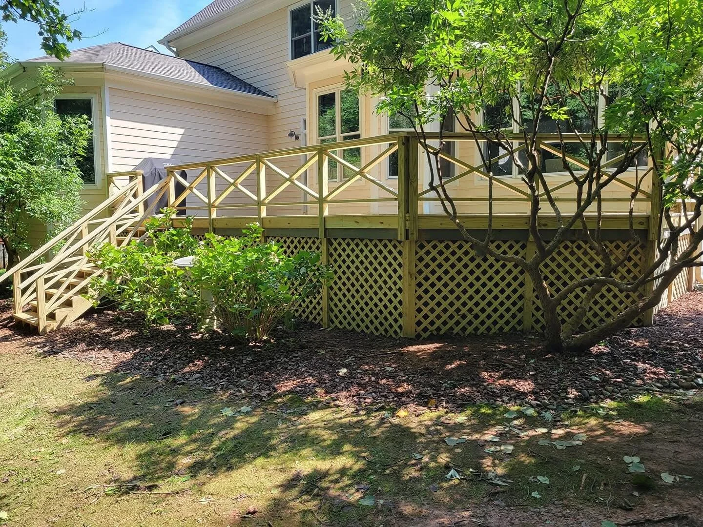 Removal and repair of old pressure treated wood deck! Our customer loved how the cross pattern railing turned out!