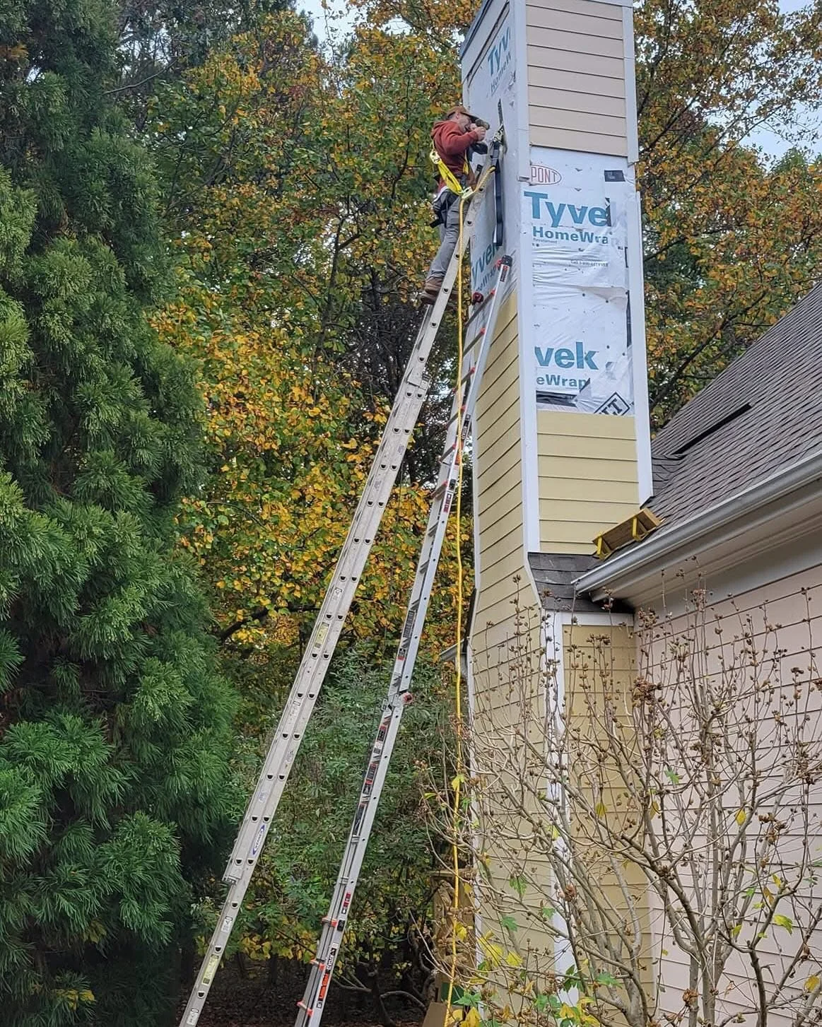 Removal of cement board siding on 40 foot chimney and replaced with new Zip board and cement board siding!