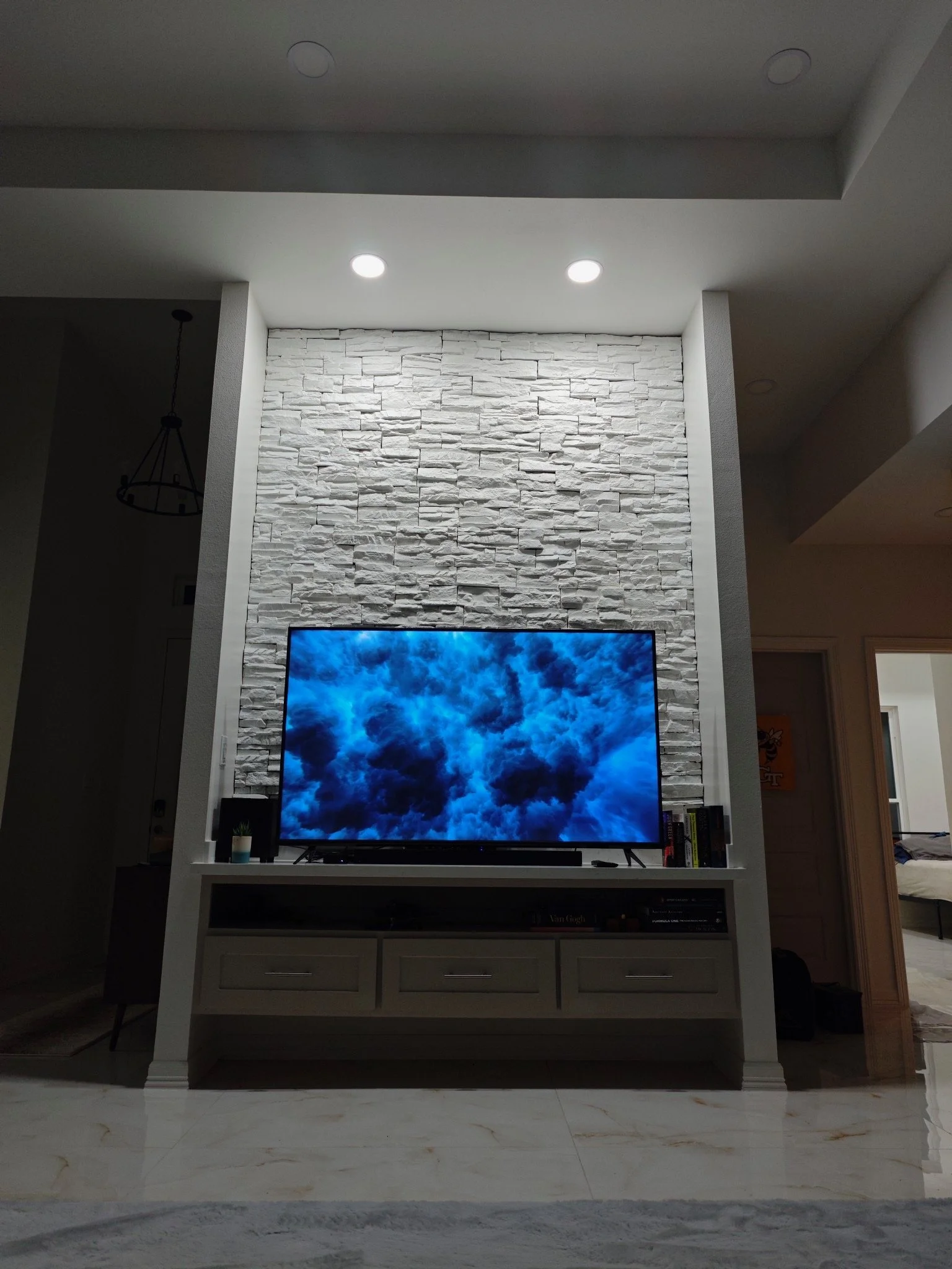 Living room remodel with stacked stone feature wall and built-in media cabinet in La Crescenta, California