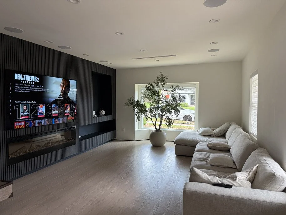 Living room remodel with black fluted accent wall, linear electric fireplace and white oak flooring in Glendale, California
