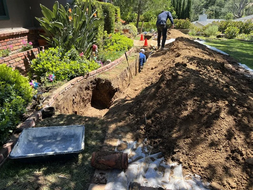 Western Building Solutions replacing a cast iron sewer line with PVC in a trenched La Cañada Flintridge front yard