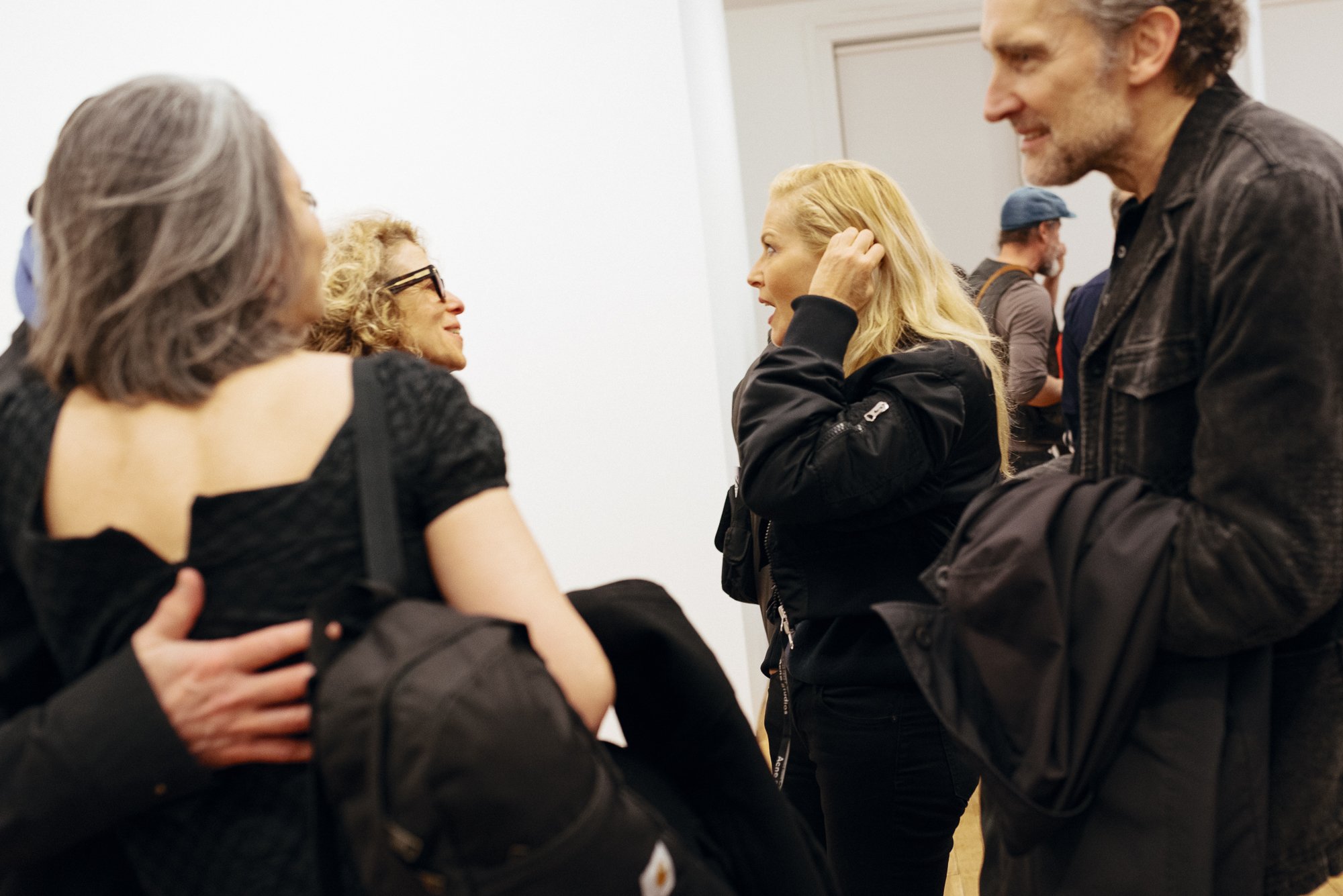 Group of people engaged in conversation at an indoor event