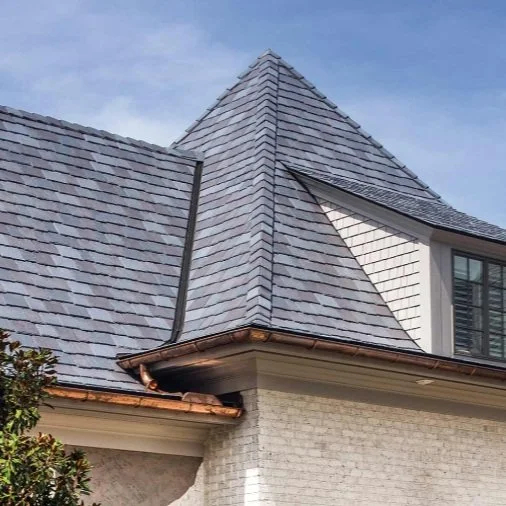 House with gray shingle roof and triangular gable