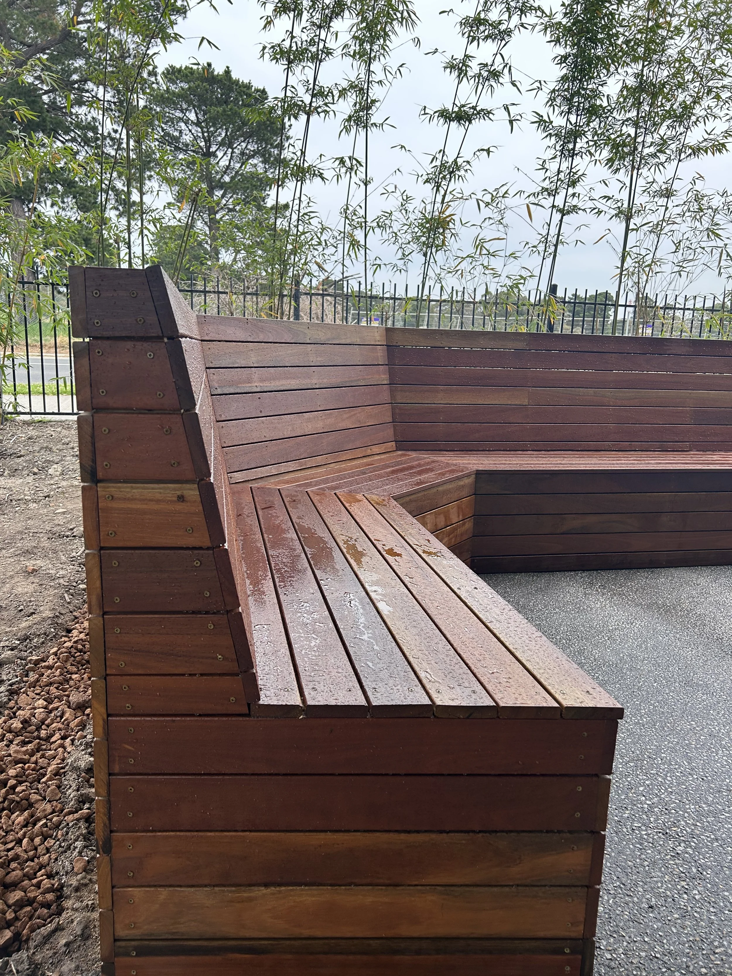Staff courtyard primary school wooden bench seating construction, exposed aggregate concreting