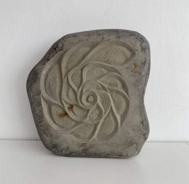 Peka Piko IV  'spiral branch' hand carved in found stone. 25cm x 20cm, with metal dowel provided for wall hanging. 2 of 4 available. $350