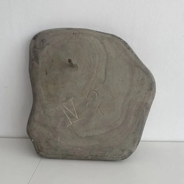 Reverse of Peka Piko, IV  'spiral branch' hand carved in found stone. 25cm x 20cm, with metal dowel provided for wall hanging. 2 of 4 available. $350