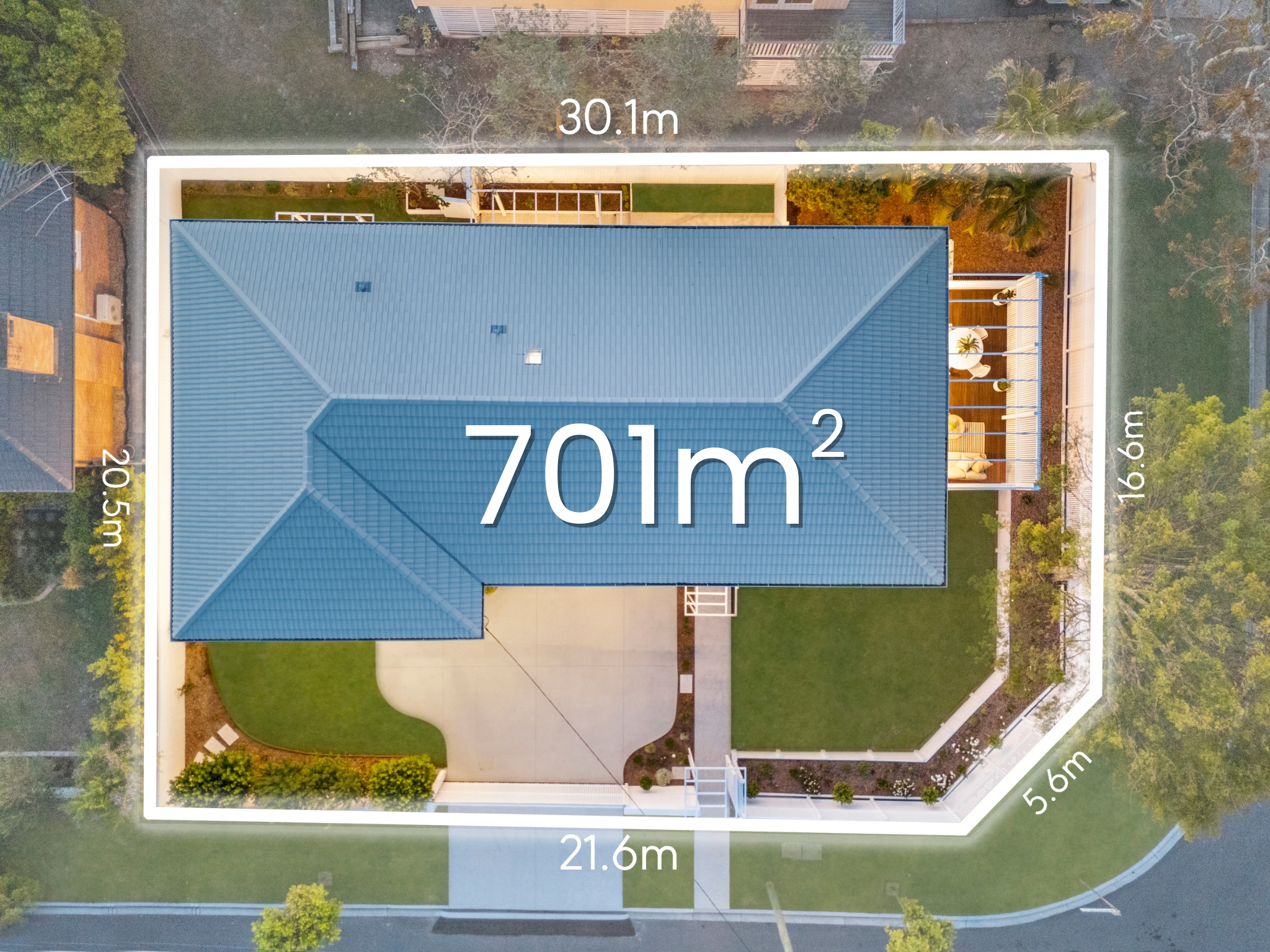 Aerial view of a house with a blue roof and green yard, measuring 701 square meters, with property dimensions marked around the perimeter.