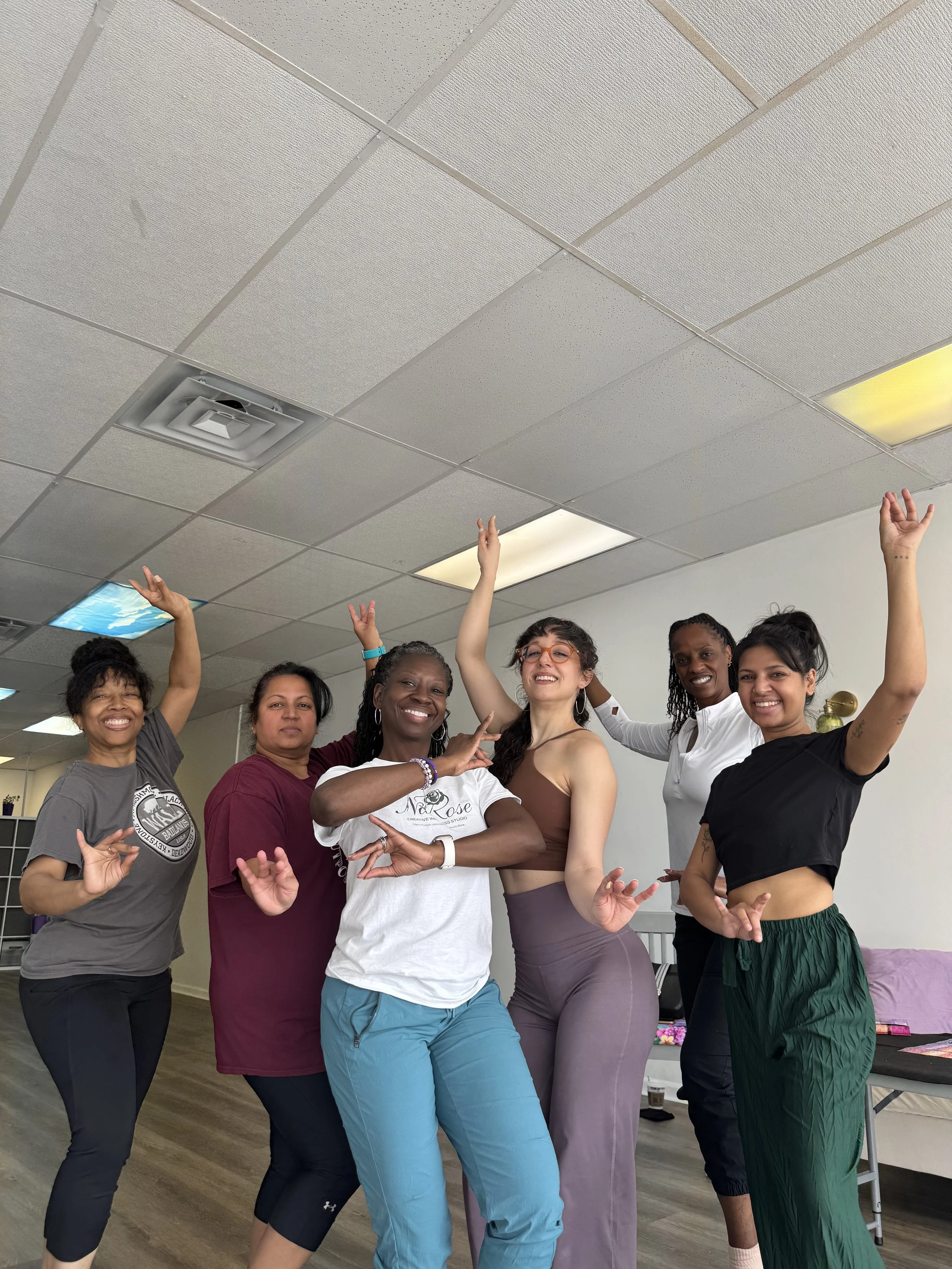 Women laughing and dancing together during a movement class at NaRose Designs Studio in Sugar Land, TX