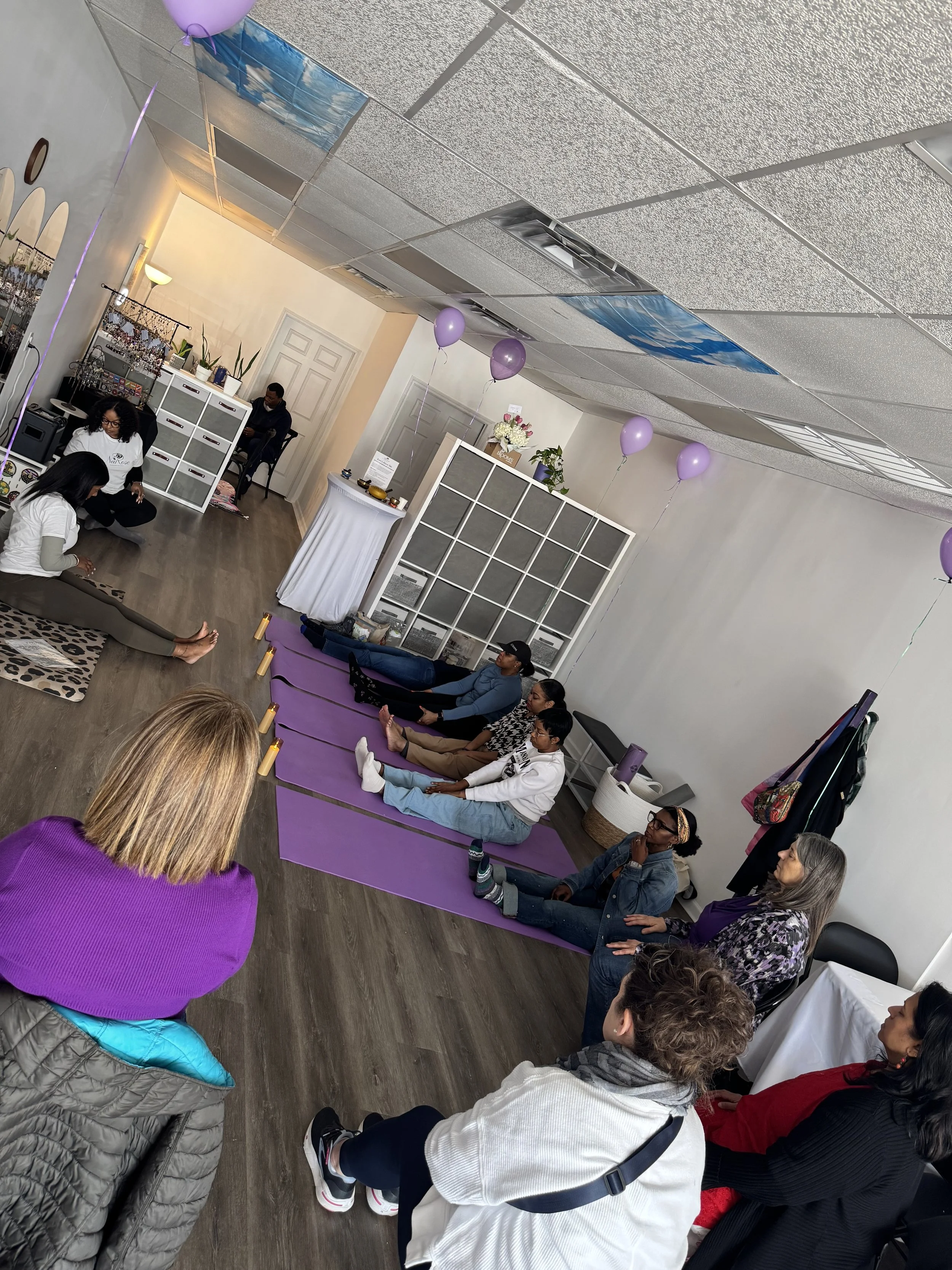 Women participating in a mindfulness and movement session at NaRose Designs Studio in Sugar Land, TX, seated on yoga mats in an intimate studio setting.”