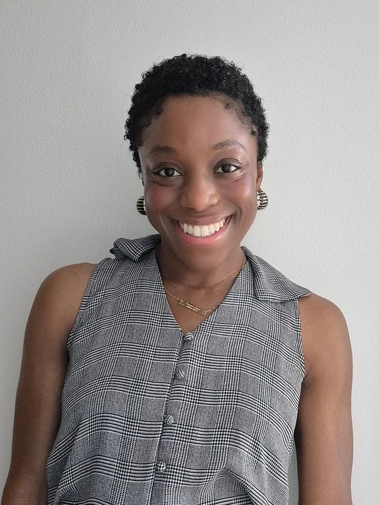 A smiling woman with short black hair and smiling.