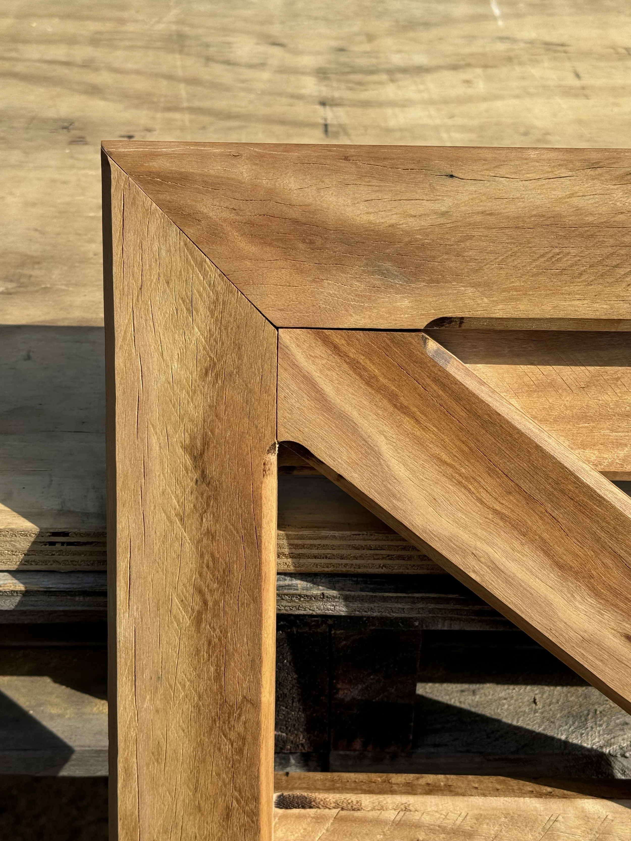 Close-up of wooden furniture corner, showing natural wood grain and craftsmanship.