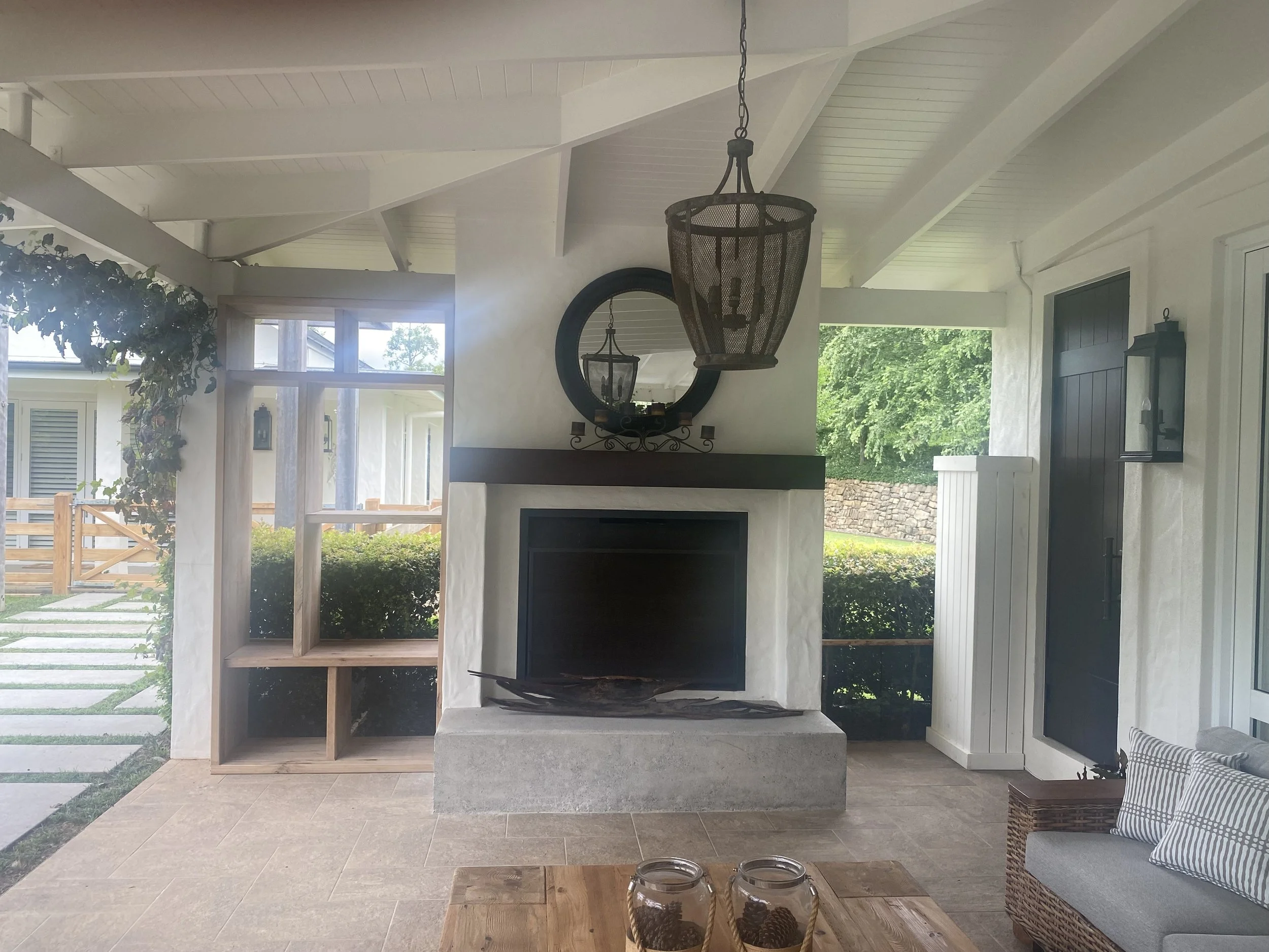 Outdoor area needing furniture, waiting for hardwood shelf system to be installed.