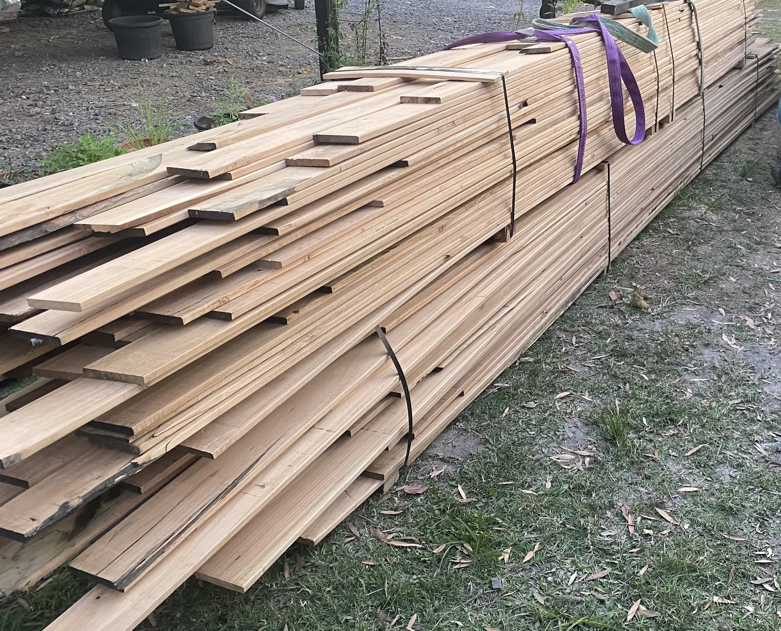 Hard wooden planks waiting to be made into a deck, using locally sourced timber from Mooloo Timber Co.