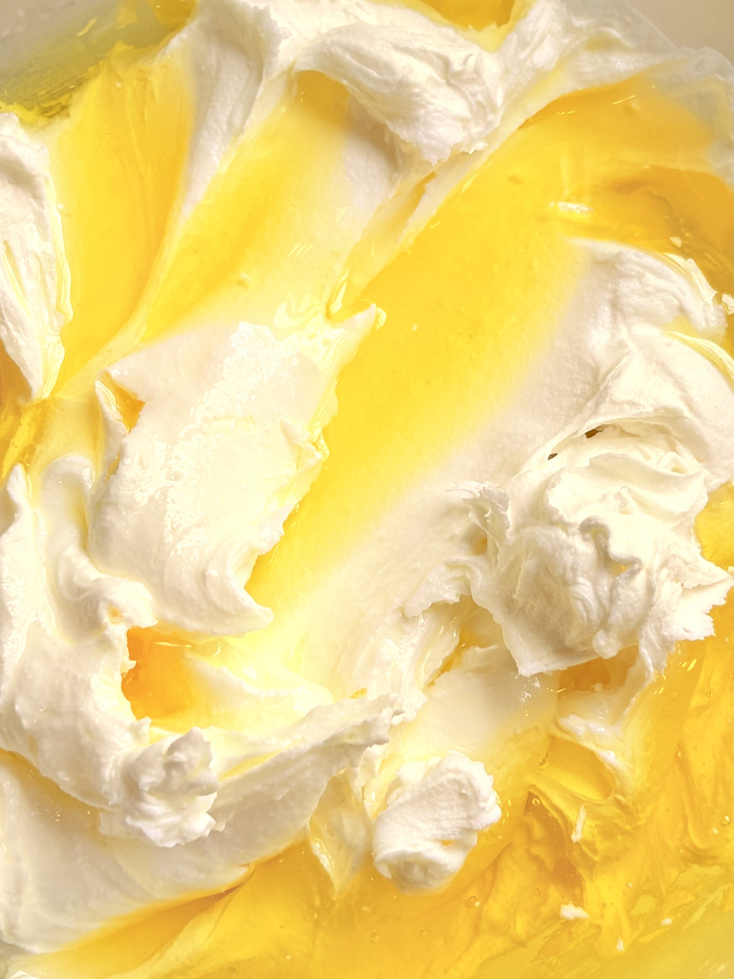 Close-up of whipped cream with lemon curd.