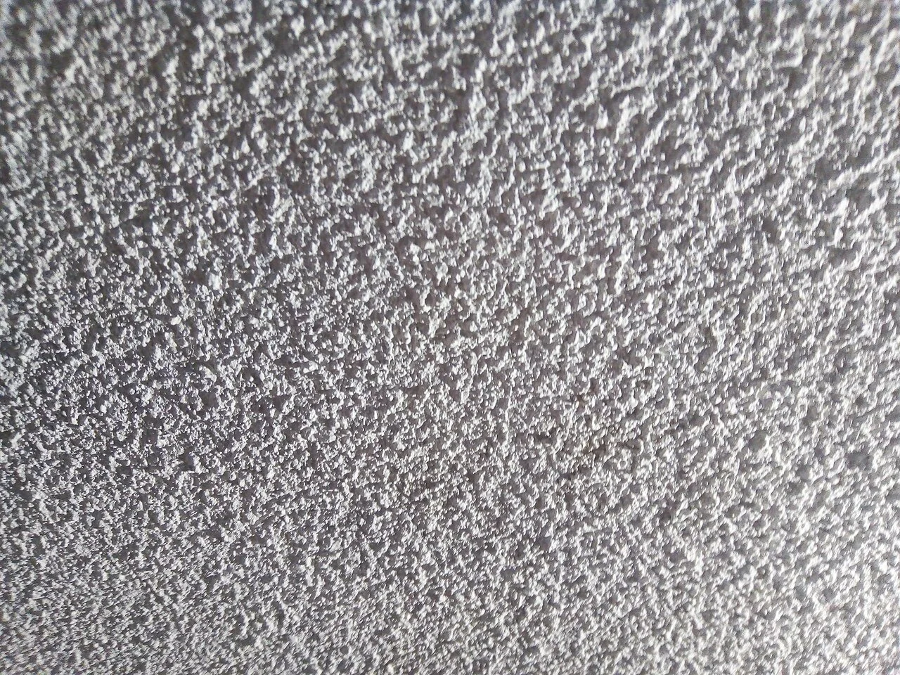 Asbestos-containing textured popcorn ceiling removal in a Kelowna residential renovation.