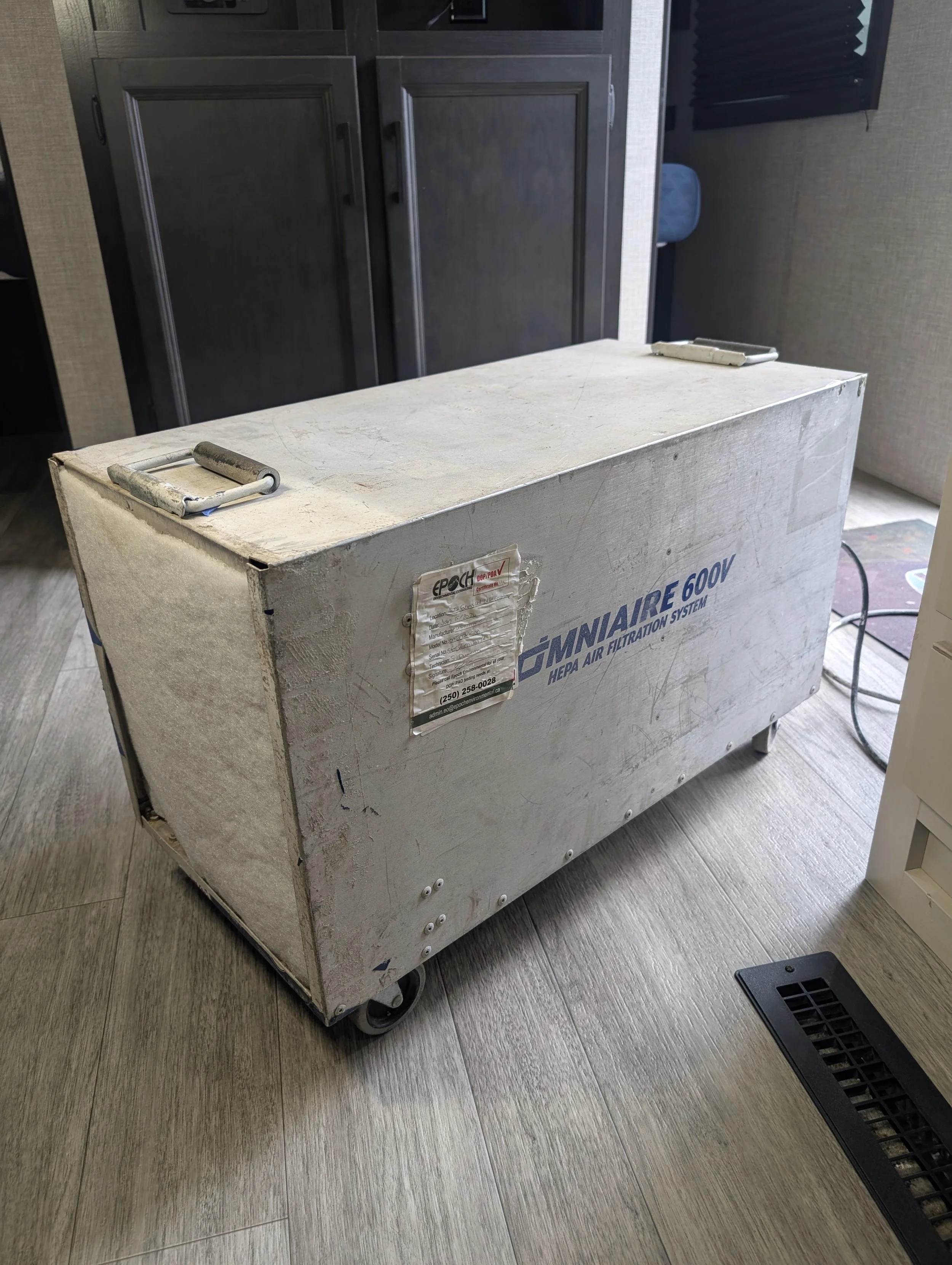 Industrial OmniAire 600V HEPA air filtration system used to create negative air pressure during a rodent remediation project in an Okanagan RV.