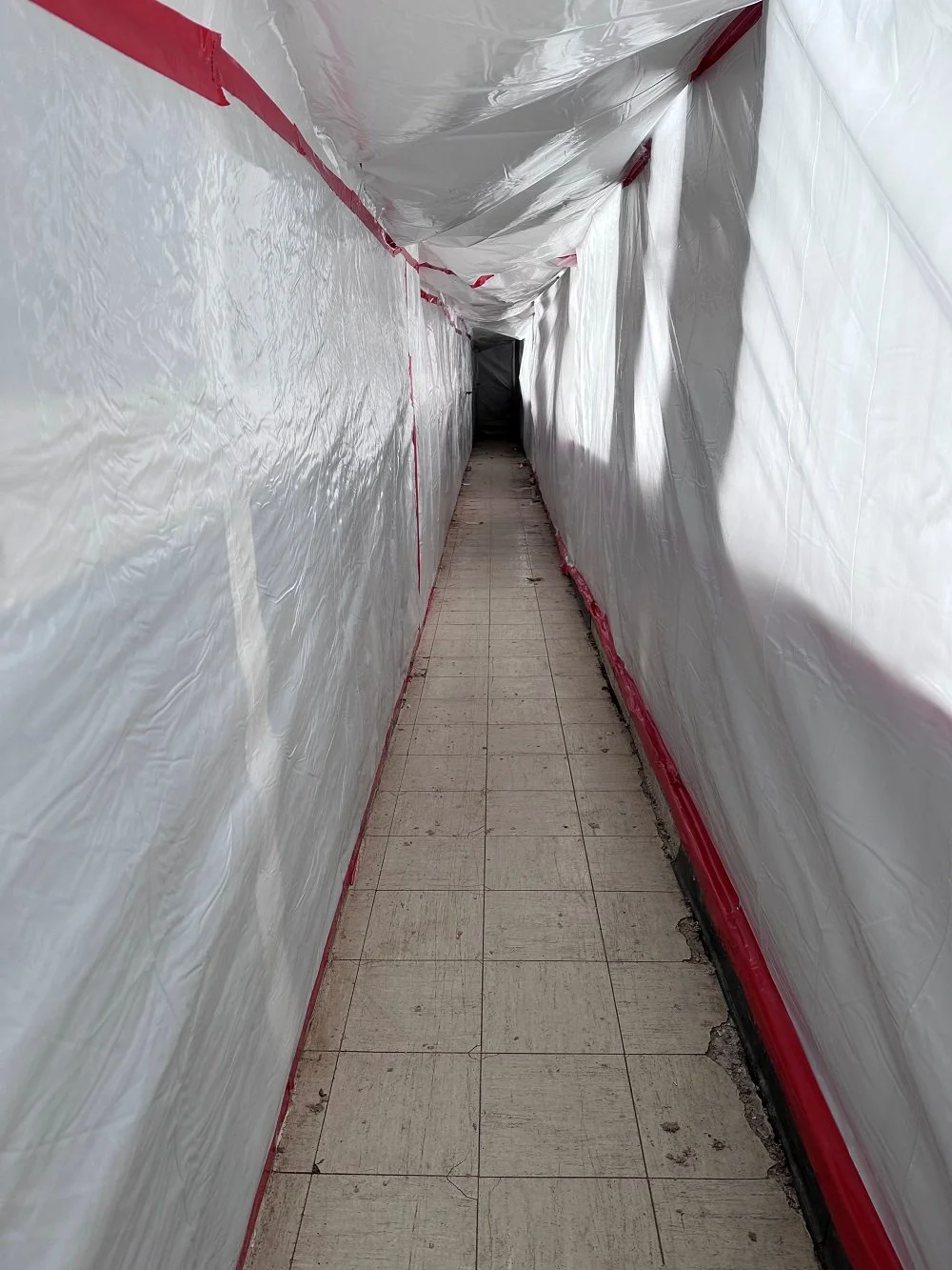 Airtight containment zone setup for safe lead tile removal in British Columbia.