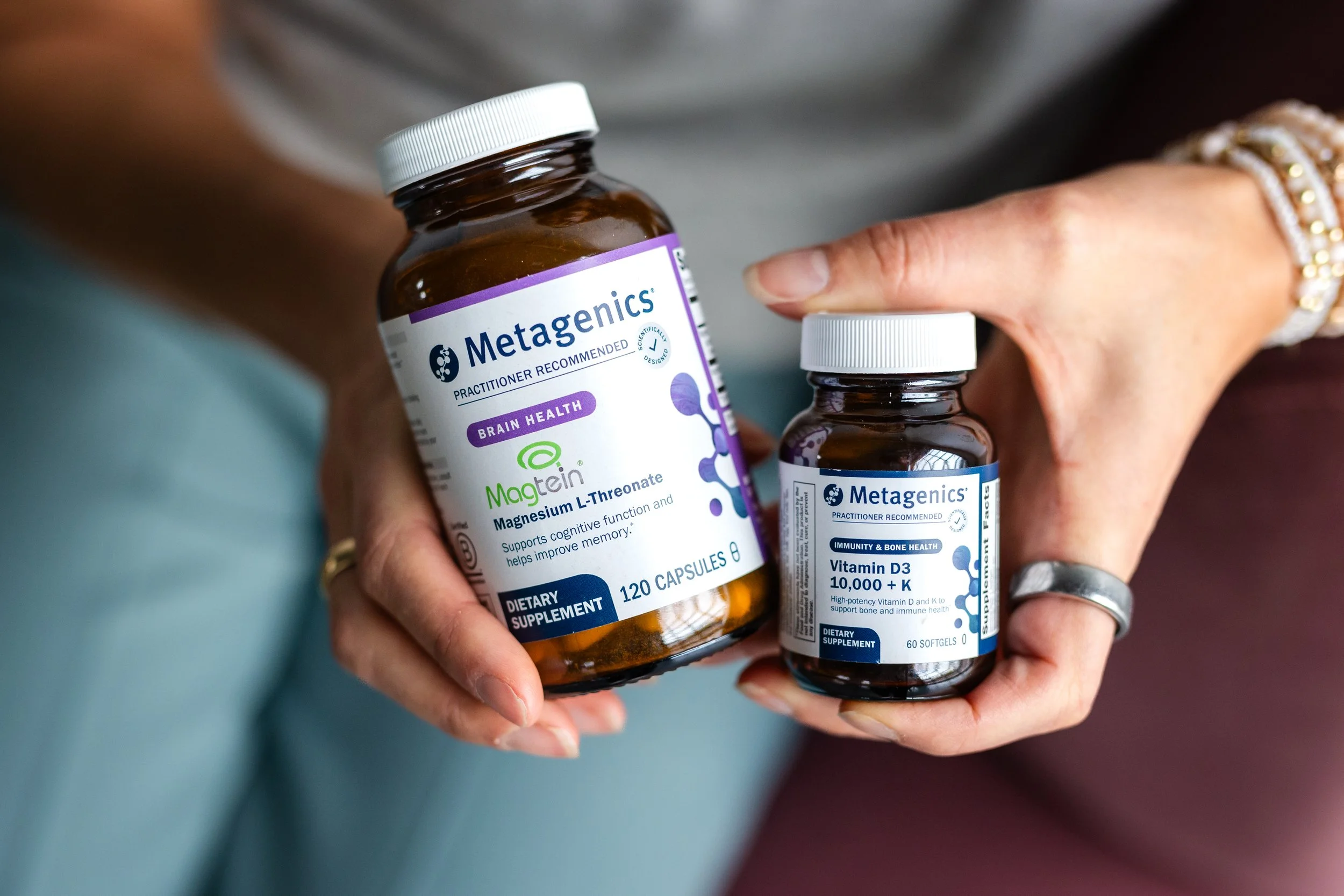 metagenics supplement support of brain health and vitamins in brown glass bottles with labels.