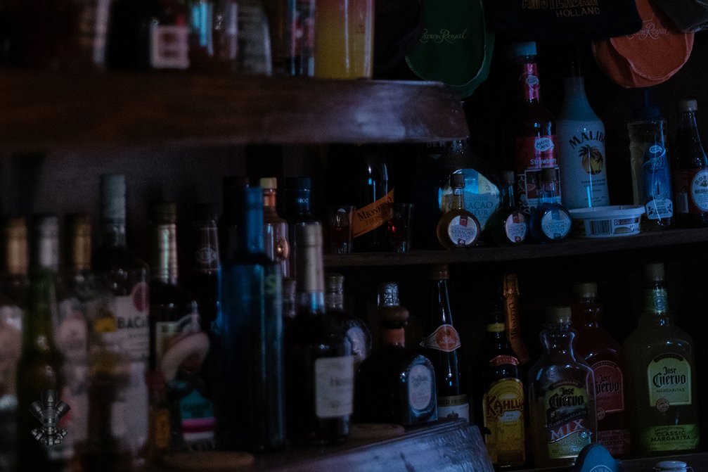 Bottles of whisky on a poll table.